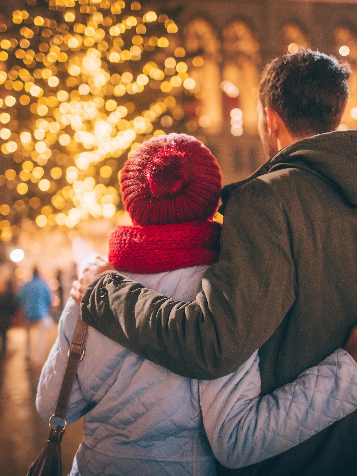 Photo of a young couple enjoy the decoration on Christmas Market, during Christmas Holidays