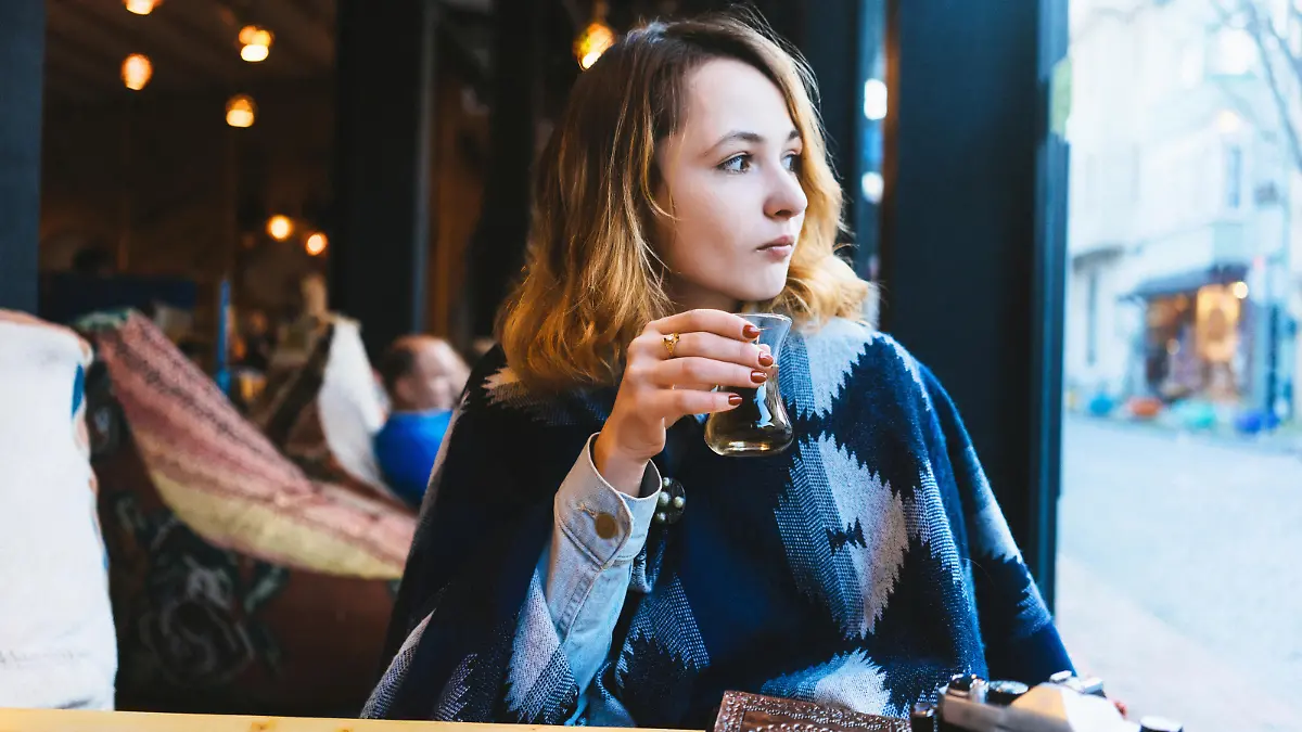 Woman drinking Turkish tea in cafe