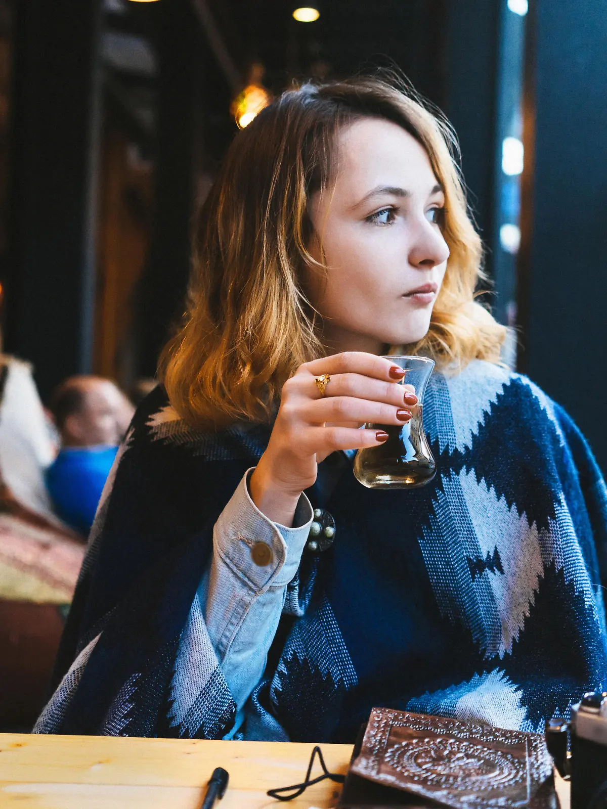 Woman drinking Turkish tea in cafe 