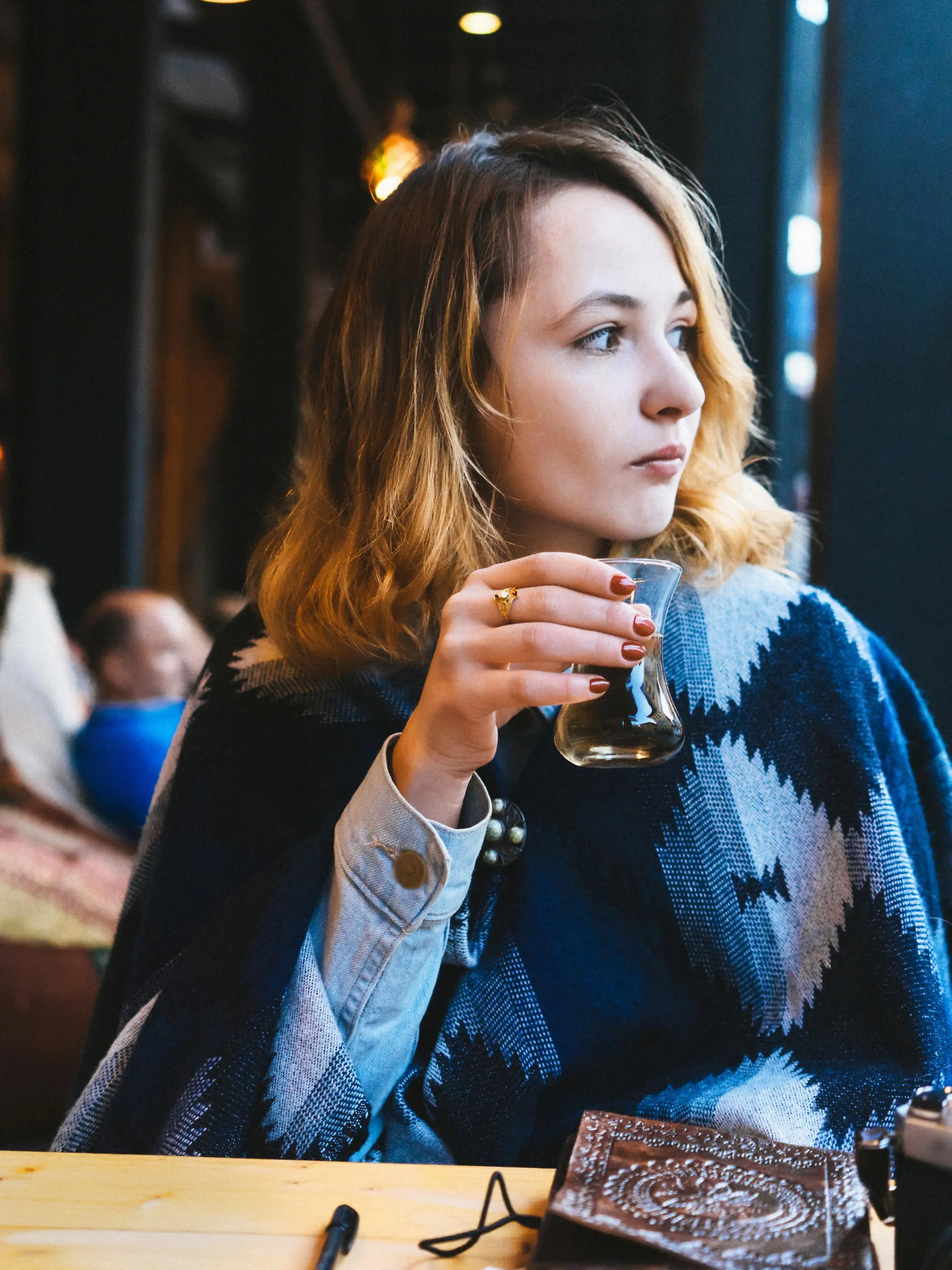 Woman drinking Turkish tea in cafe 