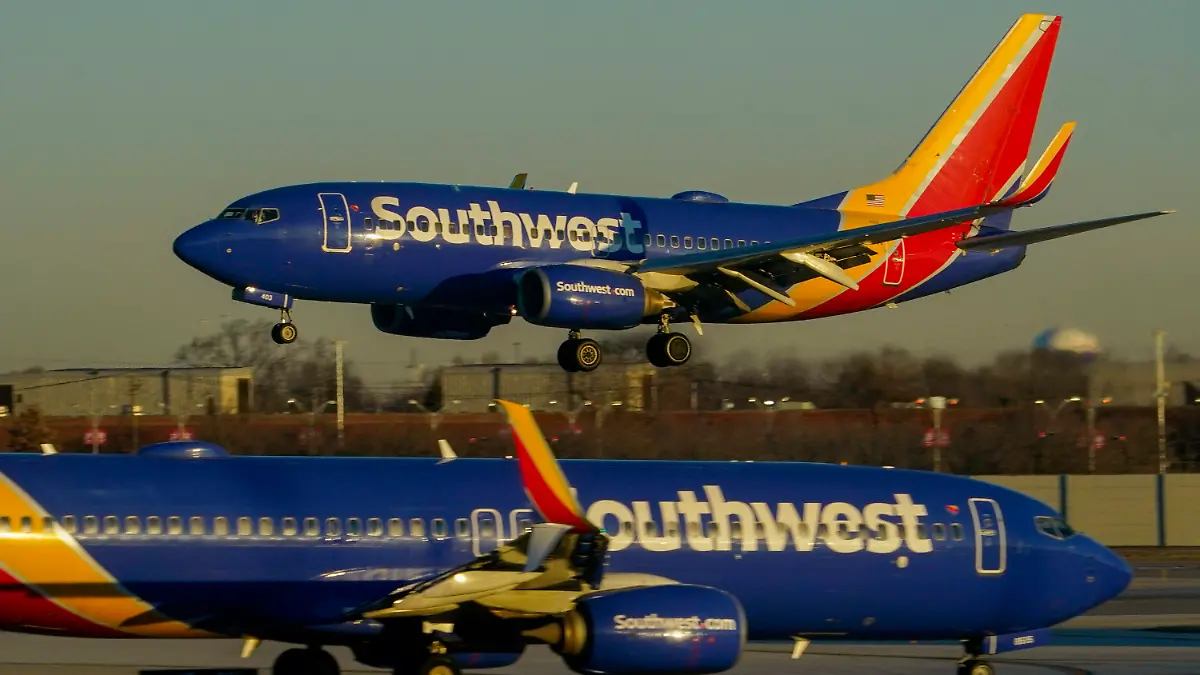 FILE - Southwest Airlines plane prepares to land at Midway International Airport, Feb. 12, 2023, in Chicago. On Monday, Oct. 16, Southwest Airlines announced that it is lowering the requirements to qualify for the top levels of its frequent-flyer program, a move aimed at travelers who are unhappy with other airlines that are making it harder to reach elite status. (AP Photo/Kiichiro Sato, File)