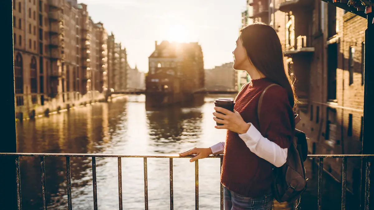 Young tourist woman is exploring Speicherstadt, old part of Hamburg, Germany