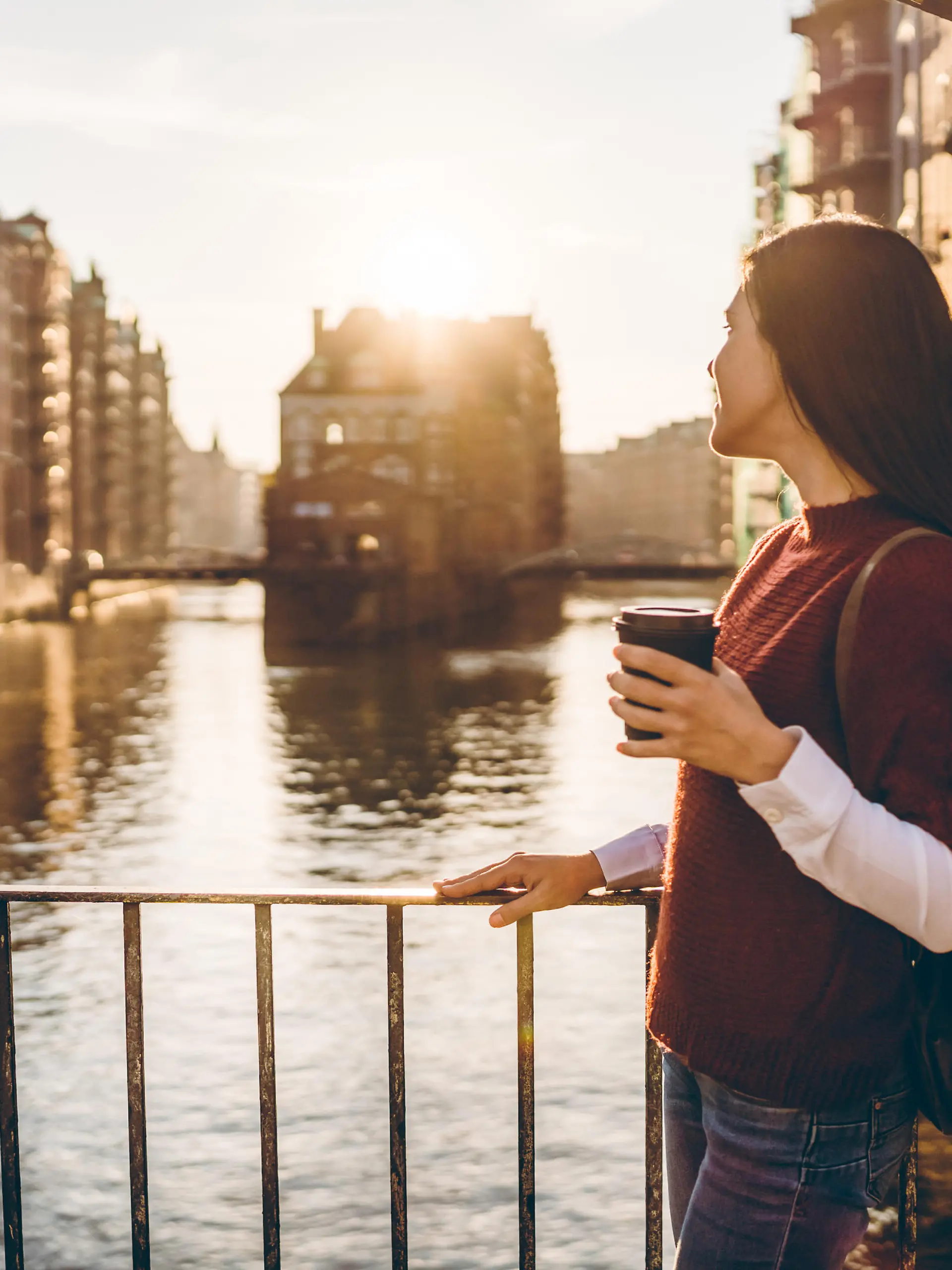 Young tourist woman is exploring Speicherstadt, old part of Hamburg, Germany
