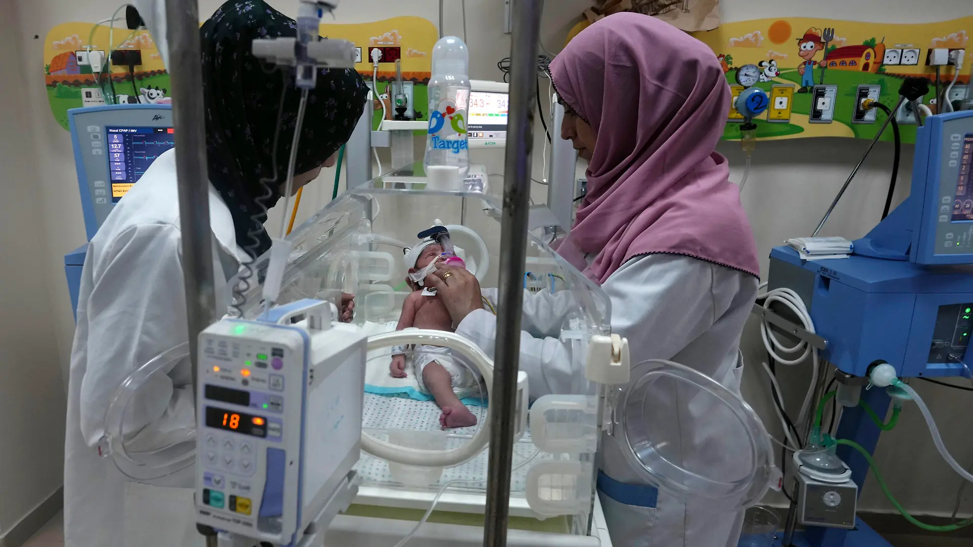 Palestinian doctors treat a prematurely born baby at Al Aqsa Hospital in Deir el-Balah, Gaza Strip, Sunday, Oct. 22, 2023. (AP Photo/Adel Hana)