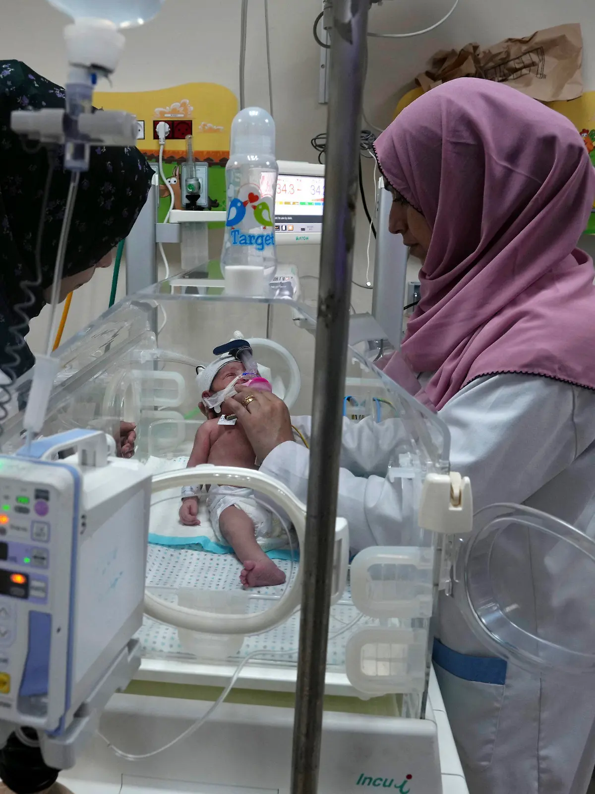 Palestinian doctors treat a prematurely born baby at Al Aqsa Hospital in Deir el-Balah, Gaza Strip, Sunday, Oct. 22, 2023. (AP Photo/Adel Hana)