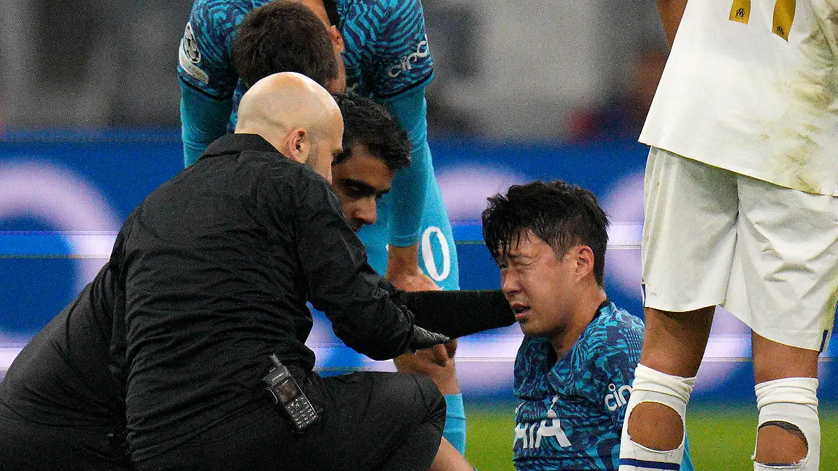 FILE - Tottenham' s Son Heung-min receives treatment after taking a knock during the Champions League Group D soccer match between Marseille and Tottenham Hotspur at the Stade Velodrome in Marseille, France, Tuesday, Nov. 1, 2022. South Korea captain Son Heung-min will undergo surgery on a facial injury, jeopardizing his availability for the World Cup in Qatar. (AP Photo/Daniel Cole, File)