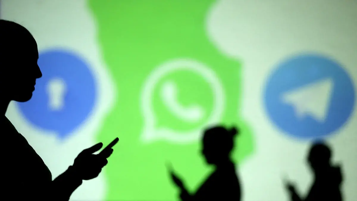 FILE PHOTO: Silhouettes of mobile users are seen next to logos of social media apps Signal, Whatsapp and Telegram projected on a screen in this picture illustration taken March 28, 2018.  REUTERS/Dado Ruvic/Illustration/File Photo