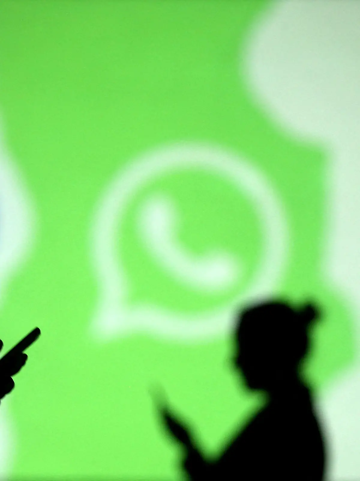 FILE PHOTO: Silhouettes of mobile users are seen next to logos of social media apps Signal, Whatsapp and Telegram projected on a screen in this picture illustration taken March 28, 2018.  REUTERS/Dado Ruvic/Illustration/File Photo