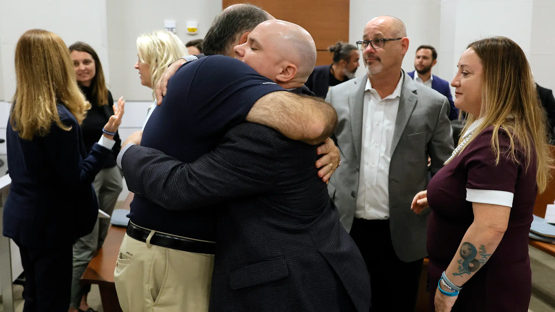 Michael Schulman, left, and Ilan Alhadeff embrace during a break in the sentencing hearing for Parkland school shooter Nikolas Cruz at the Broward County Courthouse in Fort Lauderdale, Fla., on Wednesday, Nov. 2, 2022. Schulman's son, Scott Beigel, and Alhadeff's daughter, Alyssa, were killed in the 2018 shootings. Cruz was sentenced to life in prison for murdering 17 people at Parkland's Marjory Stoneman Douglas High School more than four years ago. (Amy Beth Bennett/South Florida Sun-Sentinel via AP, Pool)