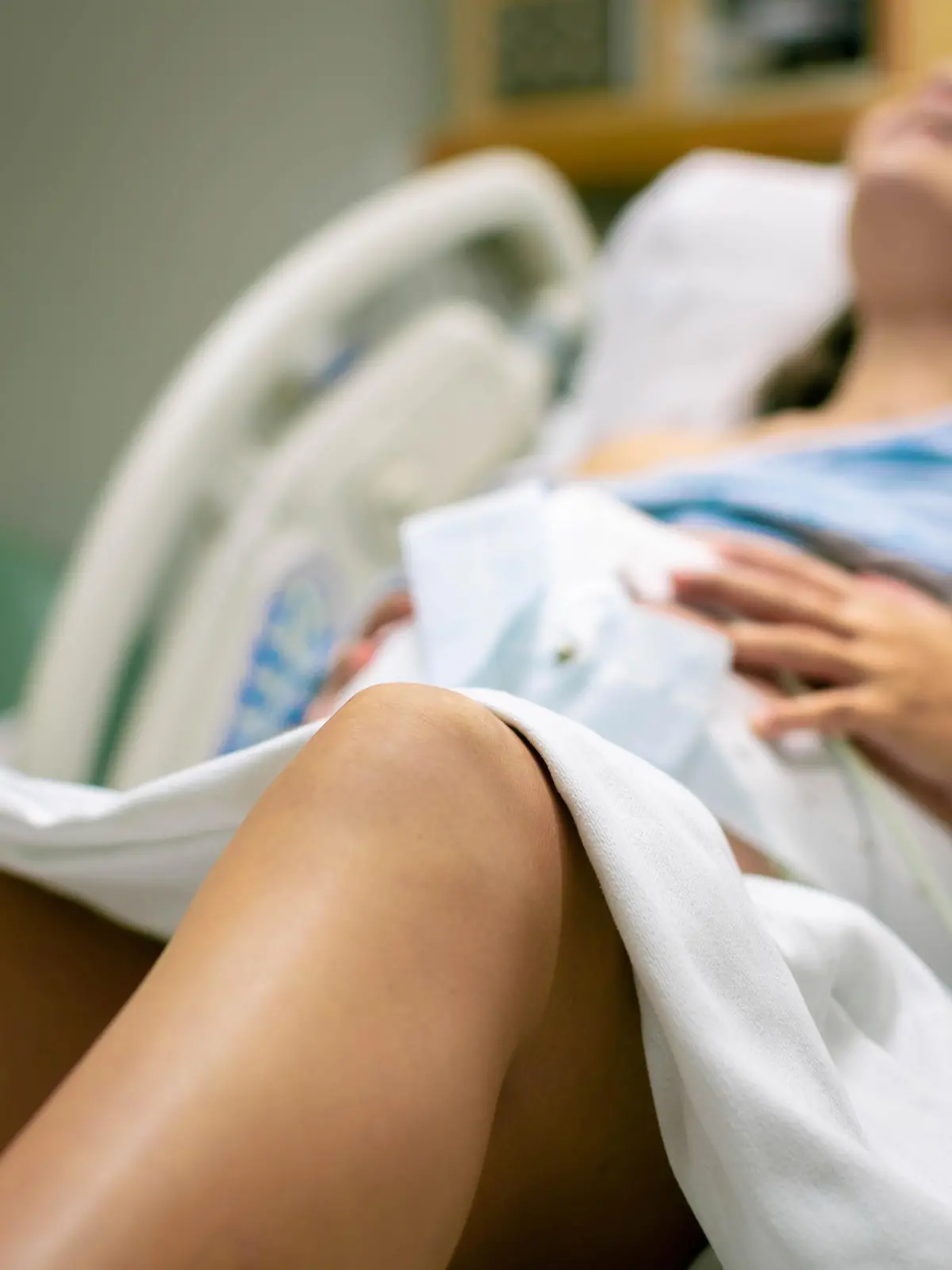A woman screaming in pain from strong contractions. Childbirth.