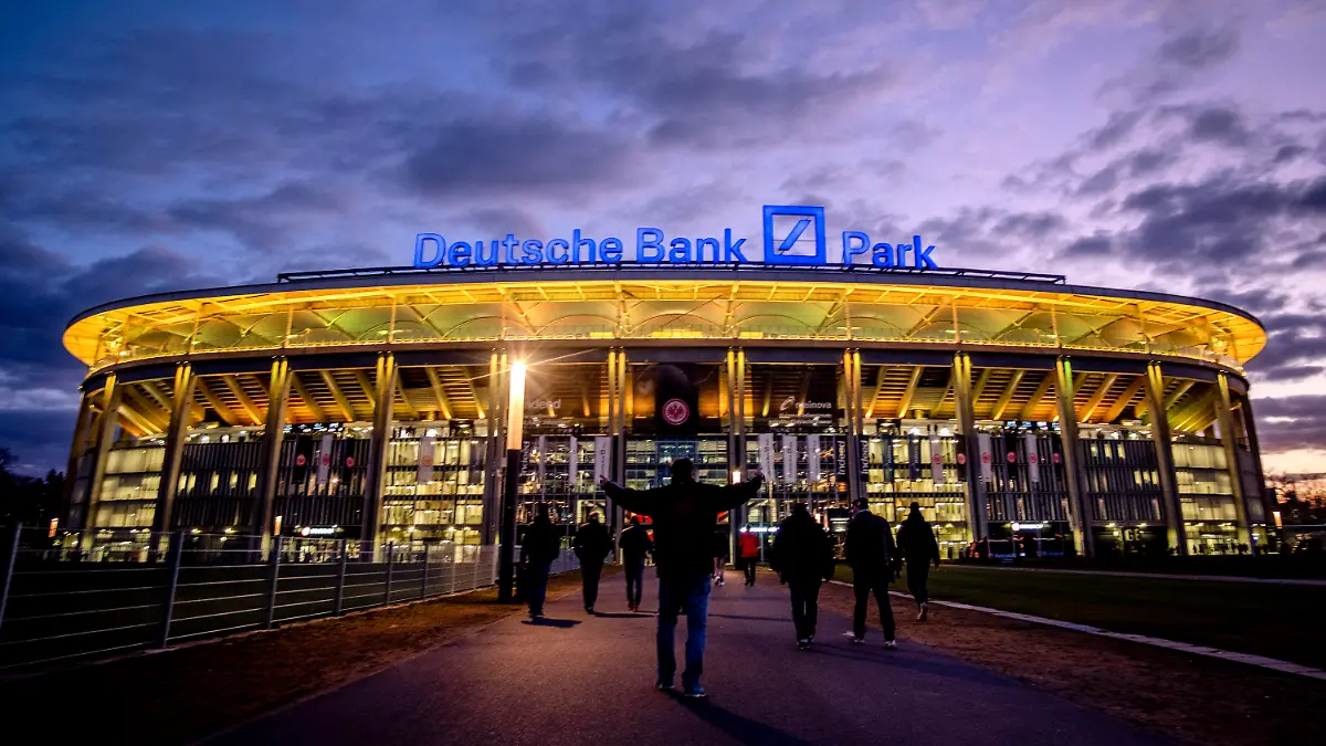 FILE - The Deutsche Bank Park is illuminated on occasion of the invasion in the Ukraine prior to a German Bundesliga soccer match between Eintracht Frankfurt and Bayern Munich in Frankfurt, Germany, Saturday, Feb. 26, 2022. The NFL says there are millions of German fans who are looking for a team to support. The Chiefs go first — they’ll play the Miami Dolphins on Sunday. A week later, the Patriots face the Indianapolis Colts. Both games are at Deutsche Bank Park. (AP Photo/Michael Probst, File)