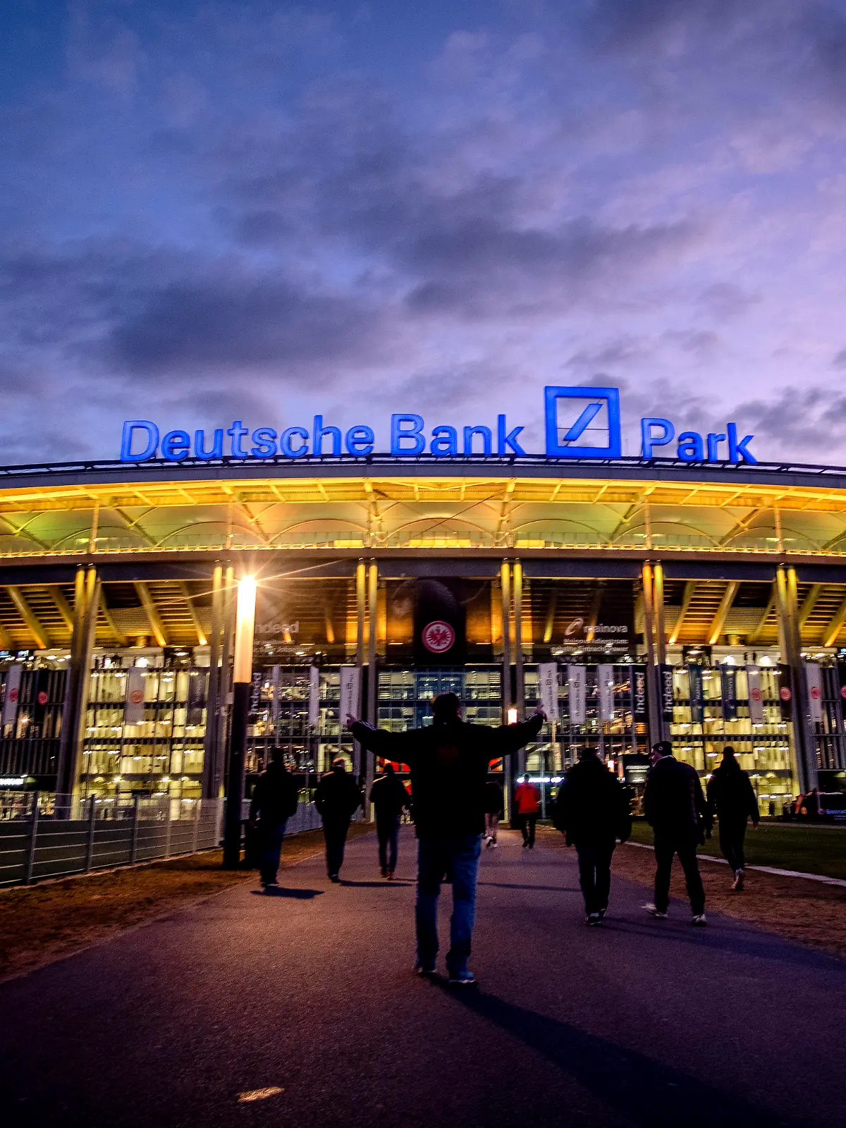 FILE - The Deutsche Bank Park is illuminated on occasion of the invasion in the Ukraine prior to a German Bundesliga soccer match between Eintracht Frankfurt and Bayern Munich in Frankfurt, Germany, Saturday, Feb. 26, 2022. The NFL says there are millions of German fans who are looking for a team to support. The Chiefs go first — they’ll play the Miami Dolphins on Sunday. A week later, the Patriots face the Indianapolis Colts. Both games are at Deutsche Bank Park. (AP Photo/Michael Probst, File)