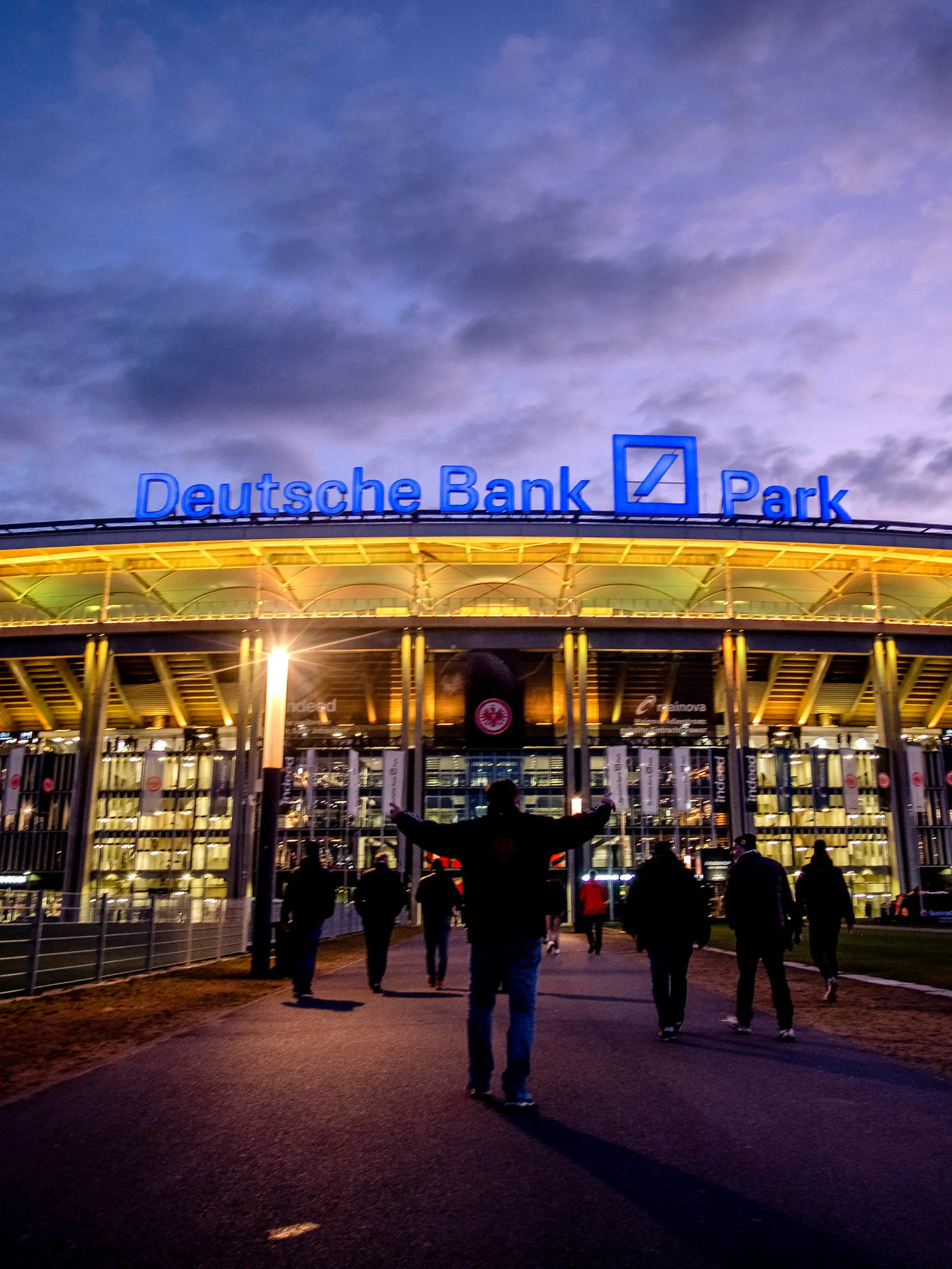 FILE - The Deutsche Bank Park is illuminated on occasion of the invasion in the Ukraine prior to a German Bundesliga soccer match between Eintracht Frankfurt and Bayern Munich in Frankfurt, Germany, Saturday, Feb. 26, 2022. The NFL says there are millions of German fans who are looking for a team to support. The Chiefs go first — they’ll play the Miami Dolphins on Sunday. A week later, the Patriots face the Indianapolis Colts. Both games are at Deutsche Bank Park. (AP Photo/Michael Probst, File)