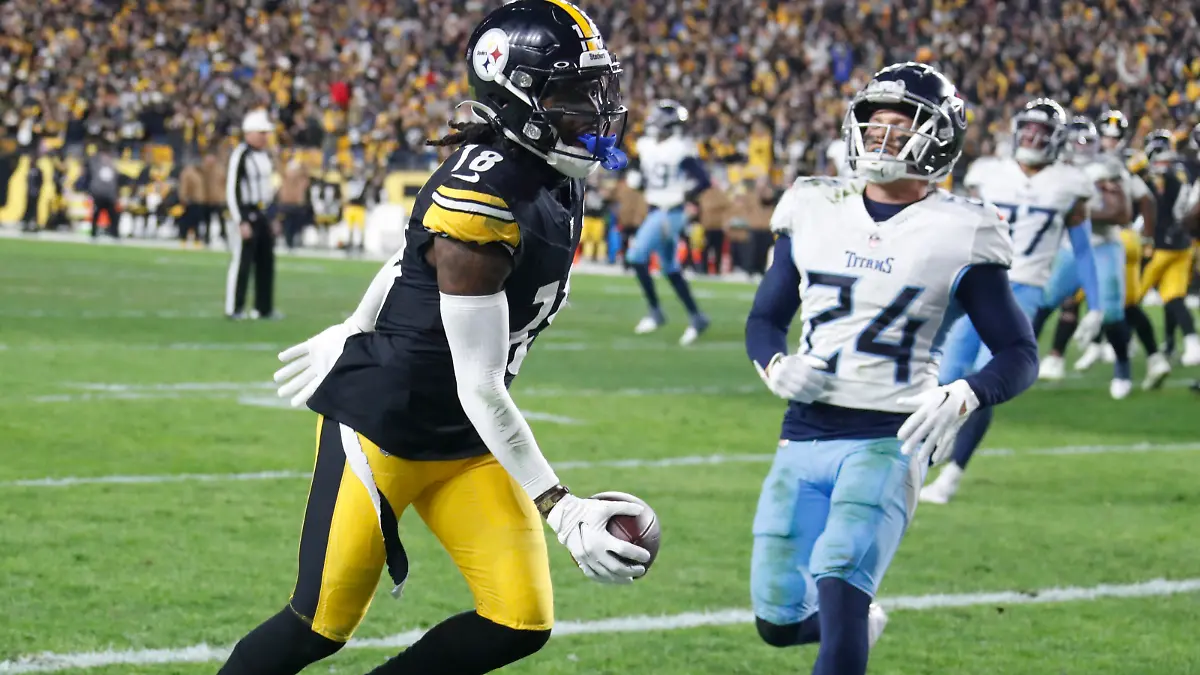 Nov 2, 2023; Pittsburgh, Pennsylvania, USA;  Pittsburgh Steelers wide receiver Diontae Johnson (18) makes the game winning touchdown against Tennessee Titans cornerback Elijah Molden (24) during the fourth quarter at Acrisure Stadium. Pittsburgh won 20-16. Mandatory Credit: Charles LeClaire-USA TODAY Sports