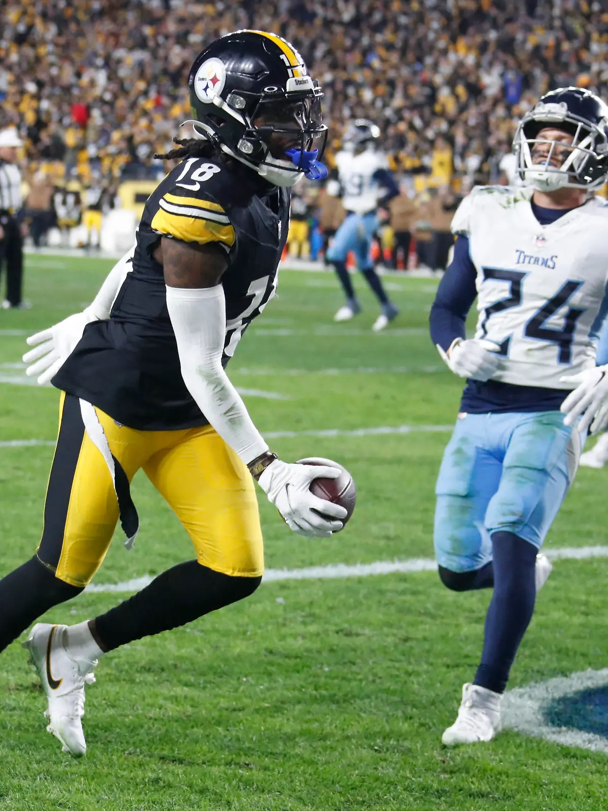 Nov 2, 2023; Pittsburgh, Pennsylvania, USA;  Pittsburgh Steelers wide receiver Diontae Johnson (18) makes the game winning touchdown against Tennessee Titans cornerback Elijah Molden (24) during the fourth quarter at Acrisure Stadium. Pittsburgh won 20-16. Mandatory Credit: Charles LeClaire-USA TODAY Sports