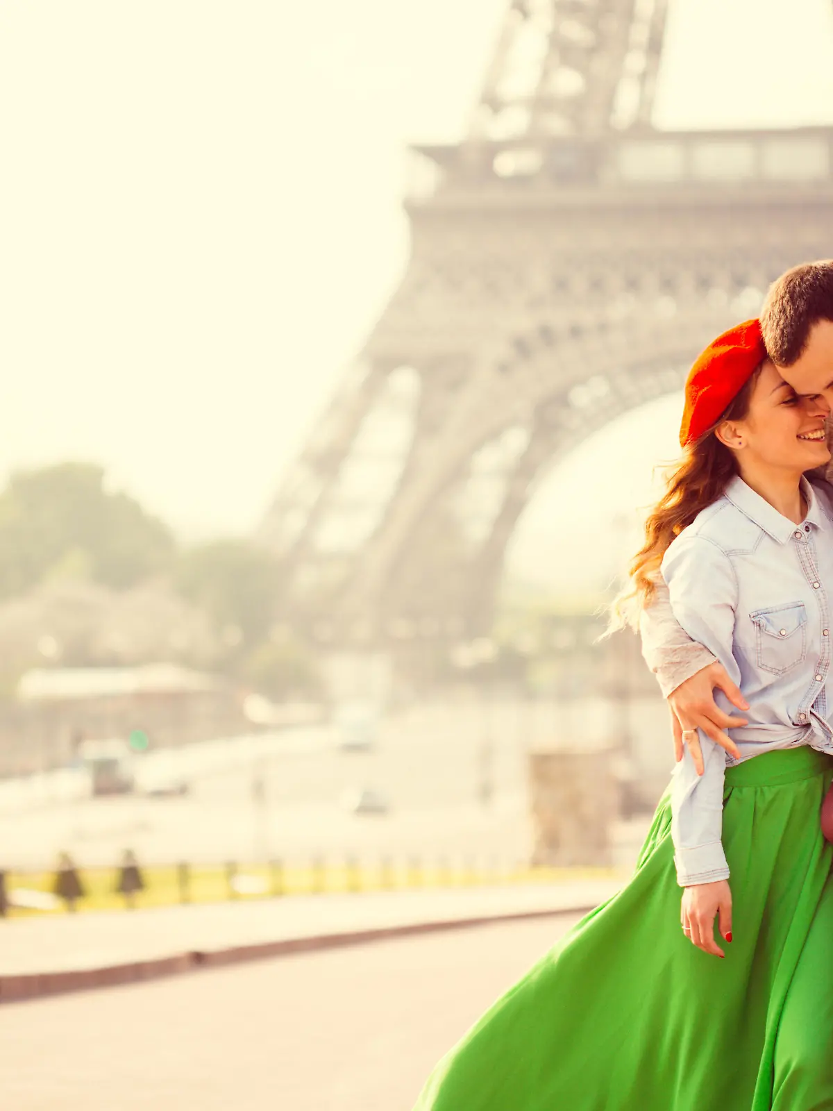 Young loving couple sharing their love and affection in front of the Eiffel tower in Paris, France. 