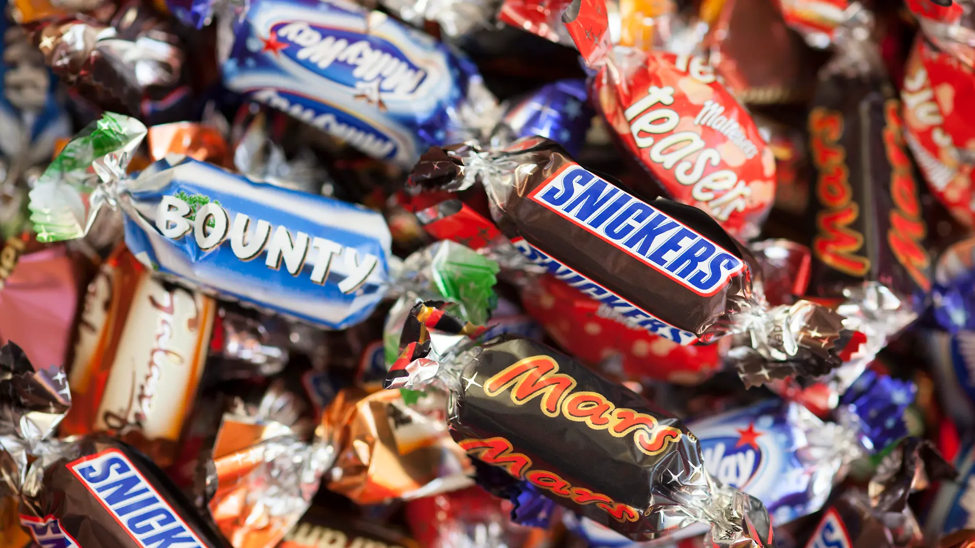Paphos, Cyprus - December 19, 2013: Snickers, Mars, Twix, Milky Way, Galaxy, Bounty and Maltesers Teasers candy heap. Full Frame. Studio shot.