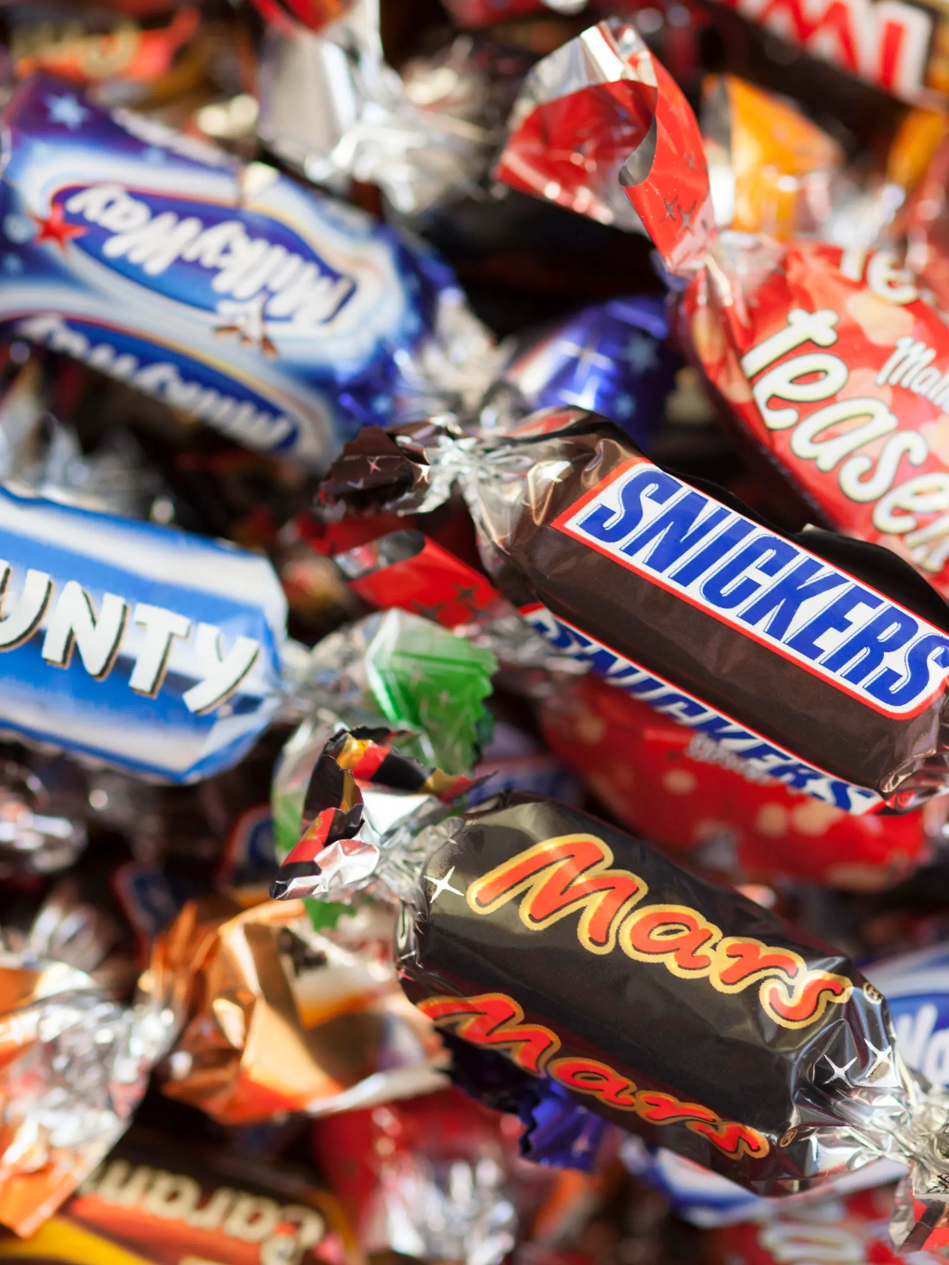Paphos, Cyprus - December 19, 2013: Snickers, Mars, Twix, Milky Way, Galaxy, Bounty and Maltesers Teasers candy heap. Full Frame. Studio shot.