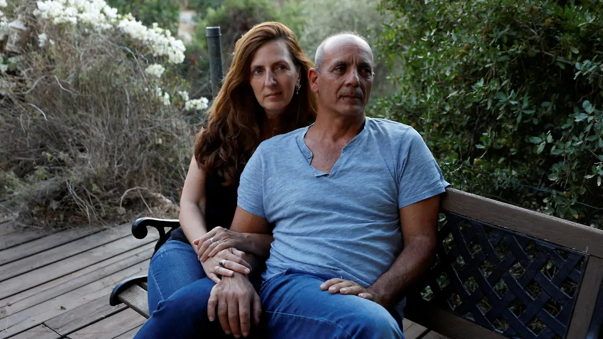 Nissim and Ricarda Louk, the parents of Shani Louk, 22, who was taken hostage by Hamas after being seized from the Nova festival, following a deadly infiltration by Hamas gunmen from the Gaza Strip into Israel, and who was later confirmed dead by Israel's government, are photographed in their home in Srigim-Li On, Israel October 31, 2023. REUTERS/Evelyn Hockstein REFILE - CORRECTING LOCATION FROM "BEIT GUVRIN " TO "SRIGIM-LI ON\
