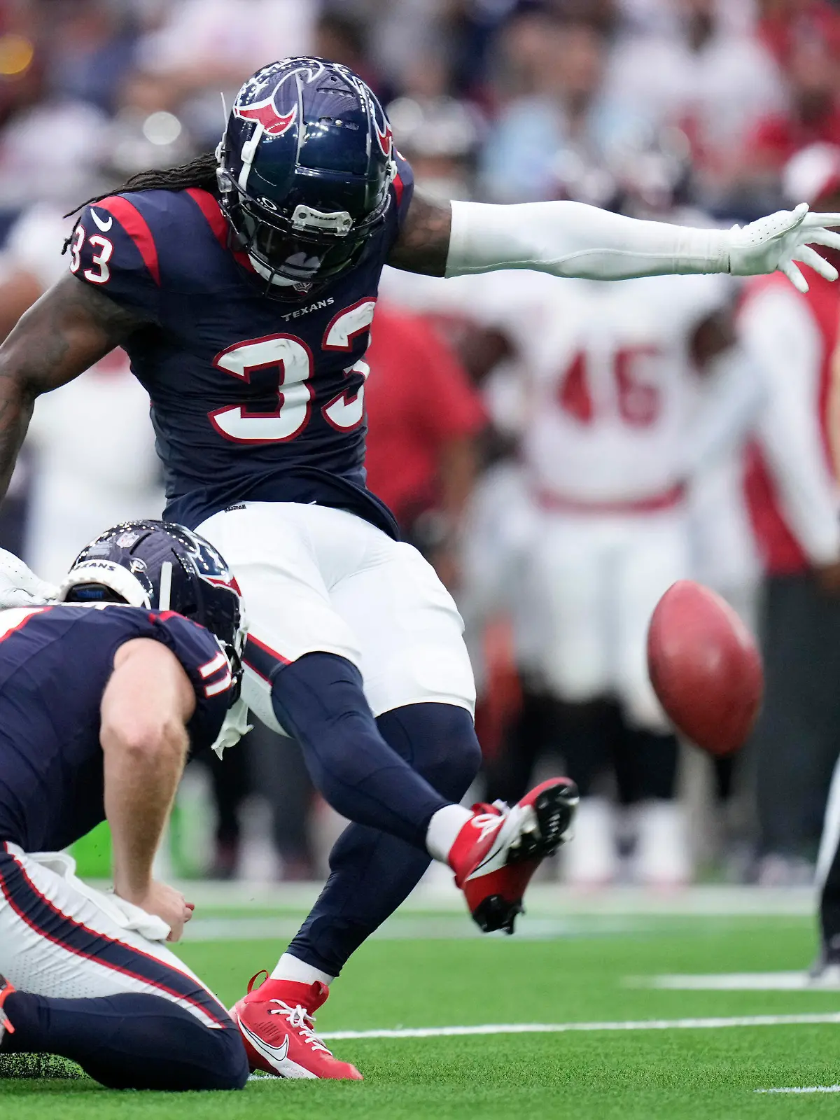 Houston Texans' Dare Ogunbowale (33), with Cameron Johnston (11) holding, kicks a field goal against the Tampa Bay Buccaneers during the second half of an NFL football game, Sunday, Nov. 5, 2023, in Houston. (AP Photo/Eric Christian Smith)