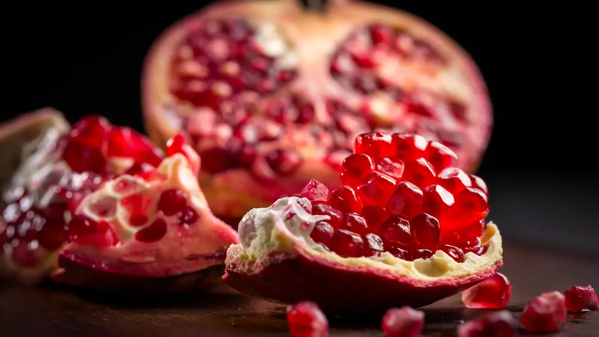 Fresh ripe pomegranate on cutting board