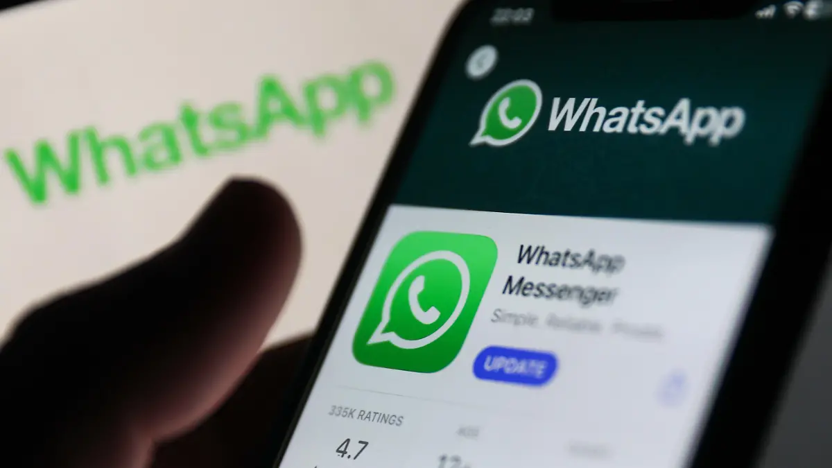 WhatsApp on App Store displayed on a phone screen and WhatsApp logo displayed on a screen in the background are seen in this illustration photo taken in Krakow, Poland on Auguust 13, 2023. (Photo by Jakub Porzycki/NurPhoto)