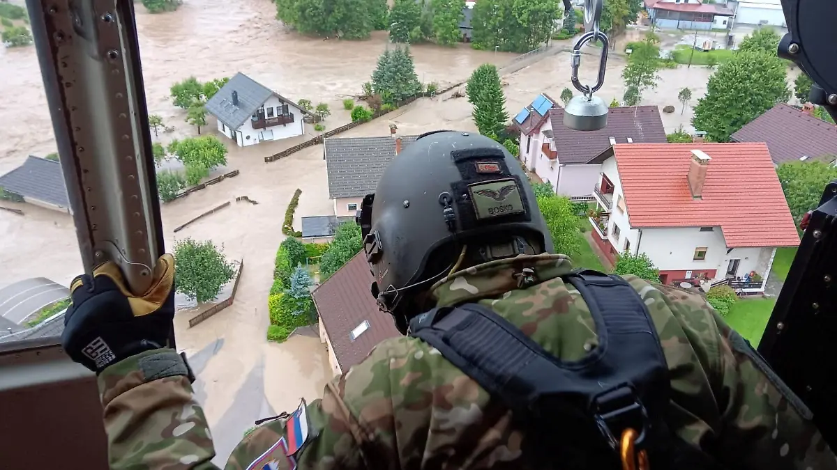 An army personnel looks at buildings submerged in floodwaters in Skofja Loka, Slovenia, August 4, 2023. Slovenian Army/Handout via REUTERS THIS IMAGE HAS BEEN SUPPLIED BY A THIRD PARTY. MANDATORY CREDIT.