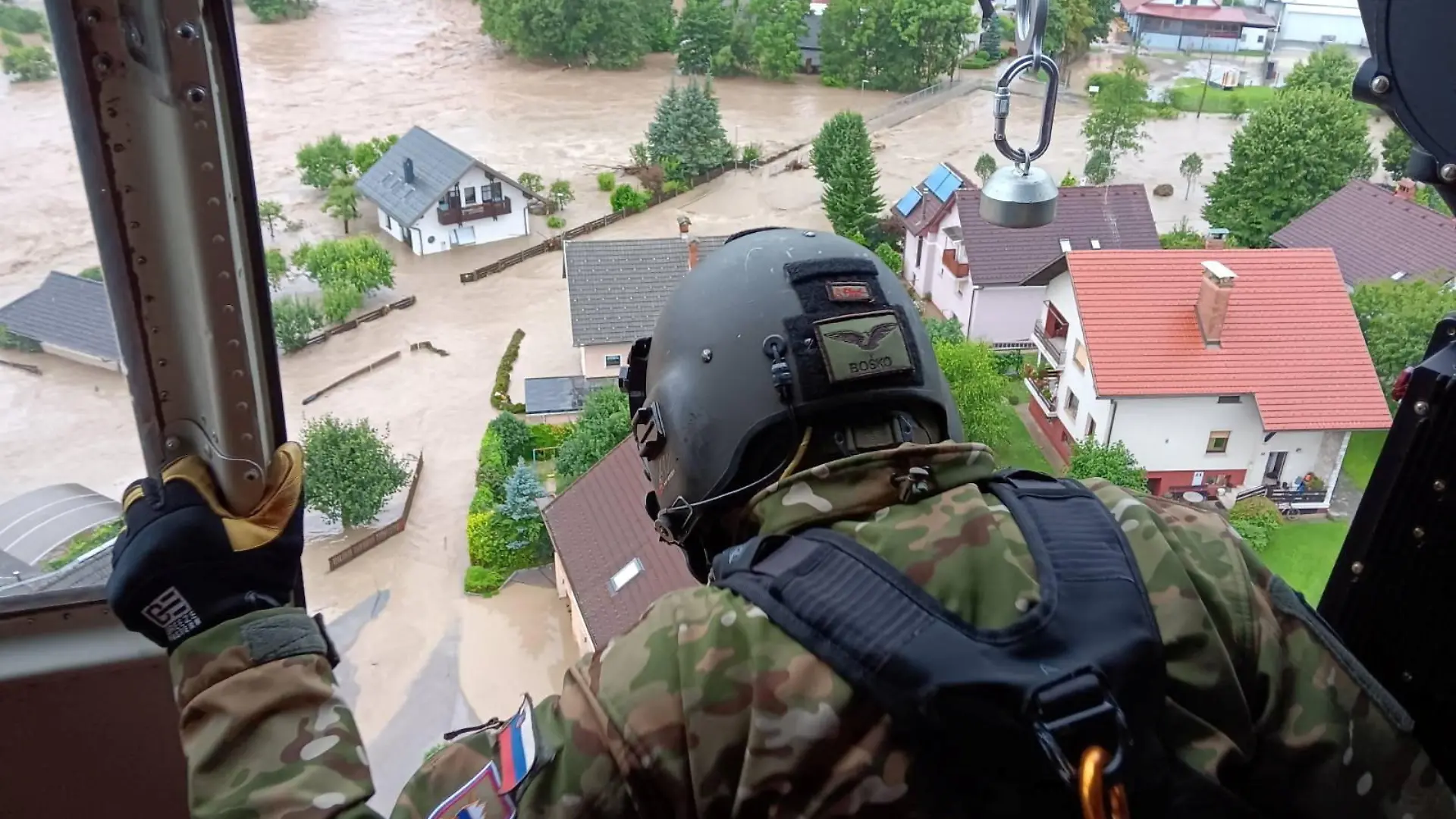 An army personnel looks at buildings submerged in floodwaters in Skofja Loka, Slovenia, August 4, 2023. Slovenian Army/Handout via REUTERS THIS IMAGE HAS BEEN SUPPLIED BY A THIRD PARTY. MANDATORY CREDIT.