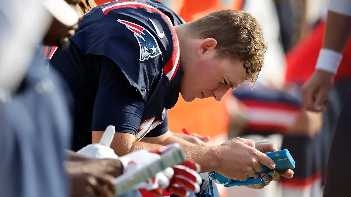 New England Patriots quarterback Mac Jones sits on the bench in the first half of an NFL football game against the Washington Commanders, Sunday, Nov. 5, 2023, in Foxborough, Mass. (AP Photo/Michael Dwyer)