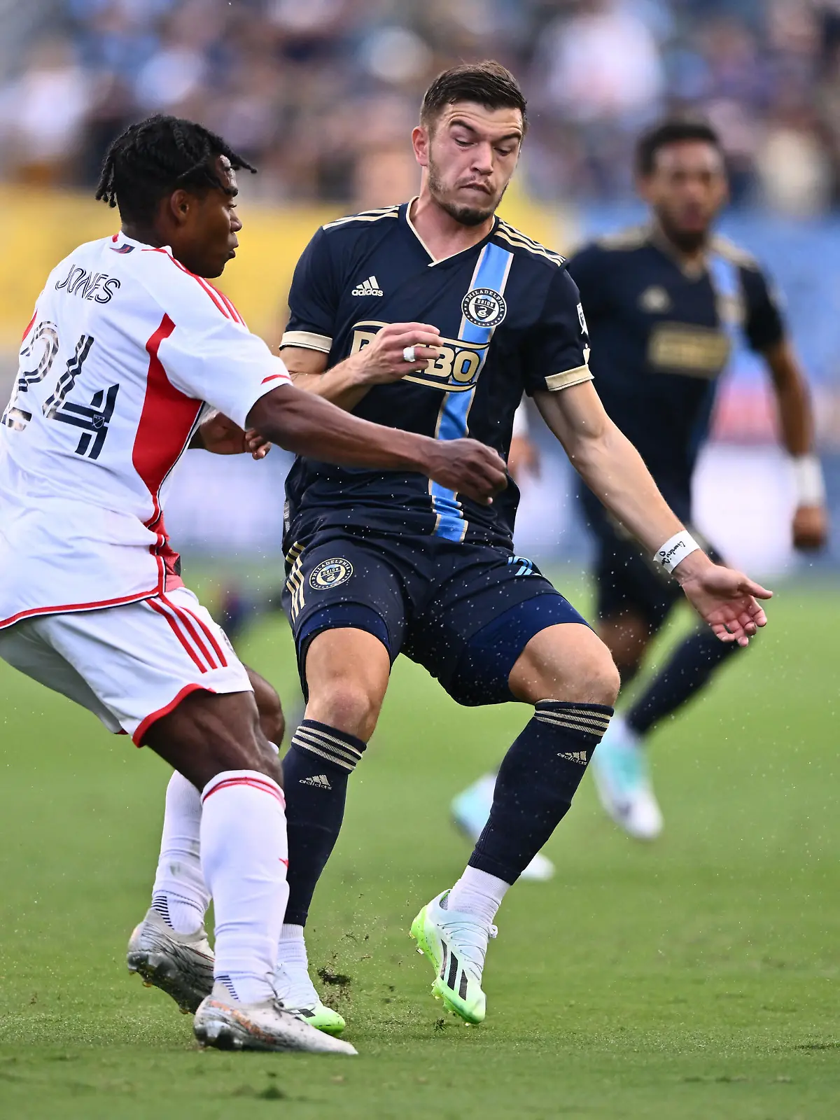 Oct 28, 2023; Philadelphia, PA, USA; Philadelphia Union defender Kai Wagner (27) passes the ball away from New England Revolution forward DeJuan Jones (24) during the first half in game one in a round one match of the 2023 MLS Cup Playoffs at Subaru Park. Mandatory Credit: Kyle Ross-USA TODAY Sports