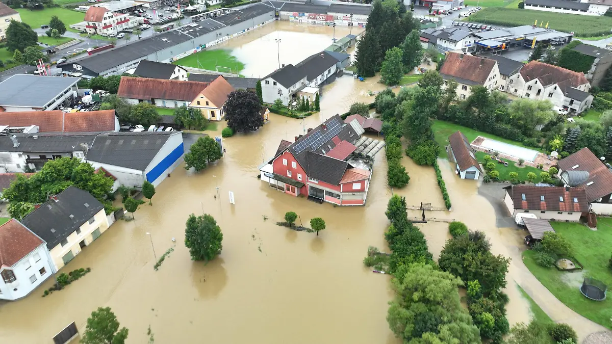 HANDOUT - 04.08.2023, Österreich, Gnas: Diese Luftaufnahme zeigt ein überflutetes Wohngebiet. Starke Regenfälle haben im Süden Österreichs in der Nacht zum Freitag Überflutungen sowie Schlamm- und Gerölllawinen ausgelöst. Foto: Unbekannt/FEUERWEHR GNAS/dpa - ACHTUNG: Nur zur redaktionellen Verwendung im Zusammenhang mit der aktuellen Berichterstattung und nur mit vollständiger Nennung des vorstehenden Credits +++ dpa-Bildfunk +++