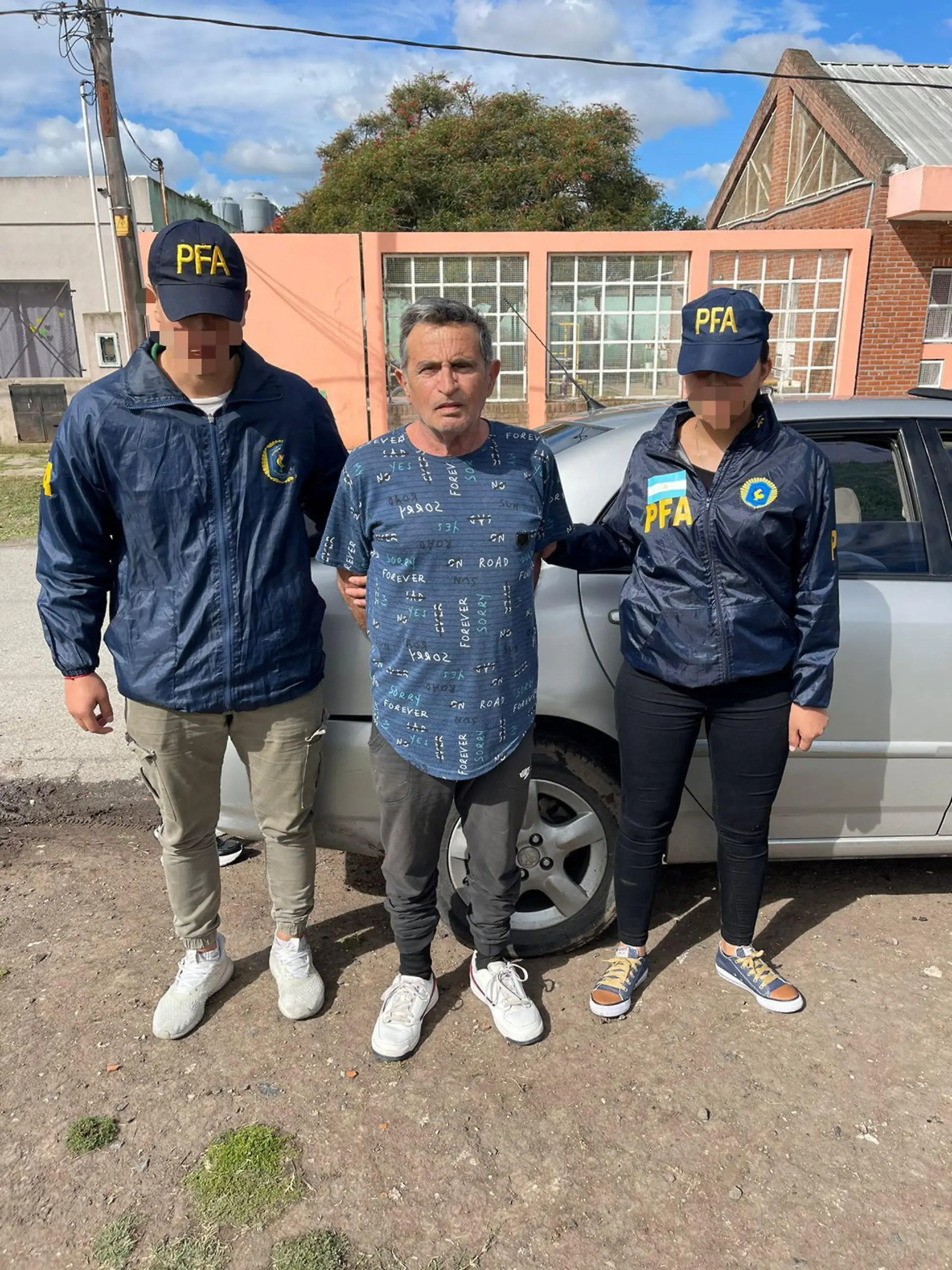Police escort Carmine Alfonso Maiorano after he was detained in Guernica, Argentina, in this undated handout image provided by Argentina's Federal Police October 31, 2022.  Policia Federal Argentina/Handout via REUTERS ATTENTION EDITORS - THIS IMAGE HAS BEEN SUPPLIED BY A THIRD PARTY. NO RESALES. NO ARCHIVES. THE IMAGE HAS BEEN BLURRED AT SOURCE.
