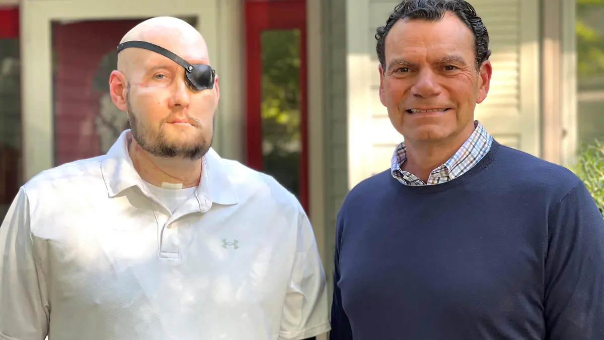 Aaron James of Hot Springs, Arkansas, poses with Dr. Eduardo D. Rodriguez after he underwent surgery for the world’s first whole-eye transplant as part of a partial face transplant at NYU Langone in an undated photograph. James survived a deadly 7200-volt electric shock while working as a high-voltage lineman in June 2021. NYU Langone Health/Handout via REUTERS NO RESALES. NO ARCHIVES. THIS IMAGE HAS BEEN SUPPLIED BY A THIRD PARTY