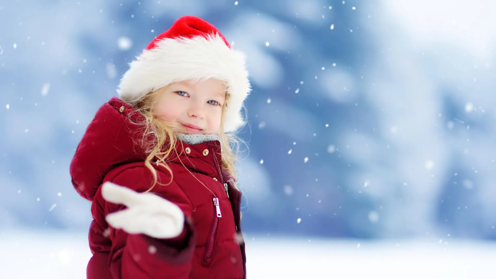 Adorable little girl having fun in beautiful winter park. Cute child playing in a snow. Winter activities for kids.
