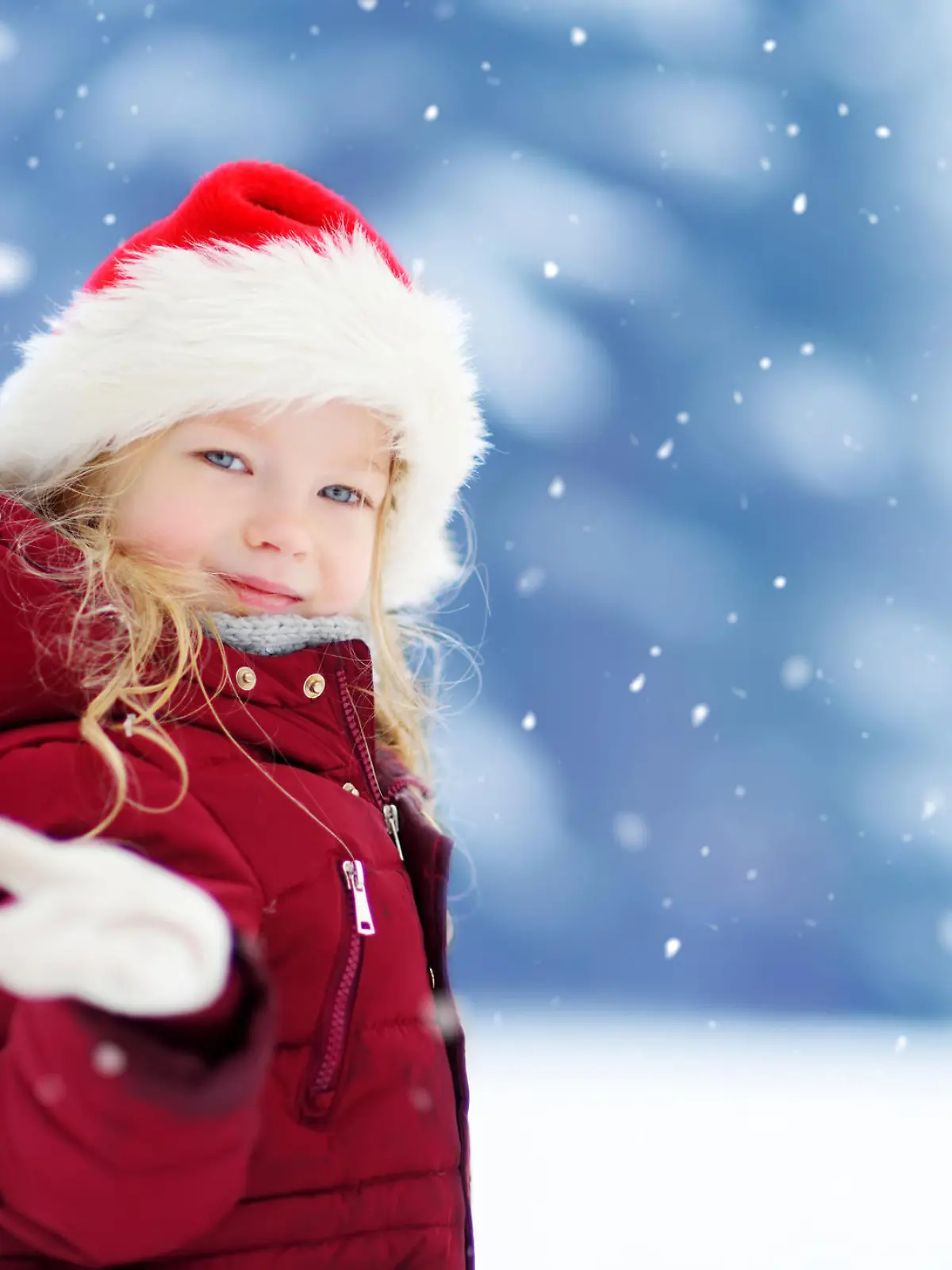 Adorable little girl having fun in beautiful winter park. Cute child playing in a snow. Winter activities for kids.