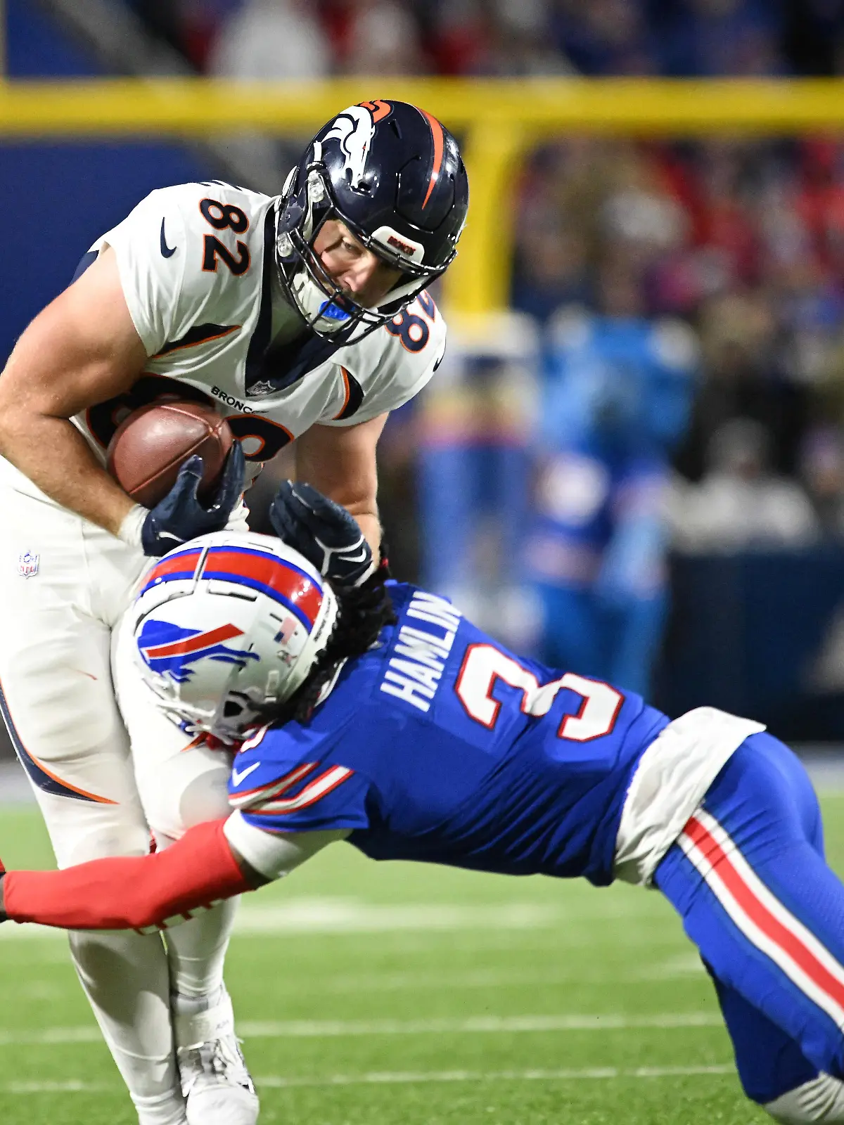 Nov 13, 2023; Orchard Park, New York, USA; Denver Broncos tight end Adam Trautman (82) is tackled by Buffalo Bills safety Damar Hamlin (3) in the fourth quarter at Highmark Stadium. Mandatory Credit: Mark Konezny-USA TODAY Sports