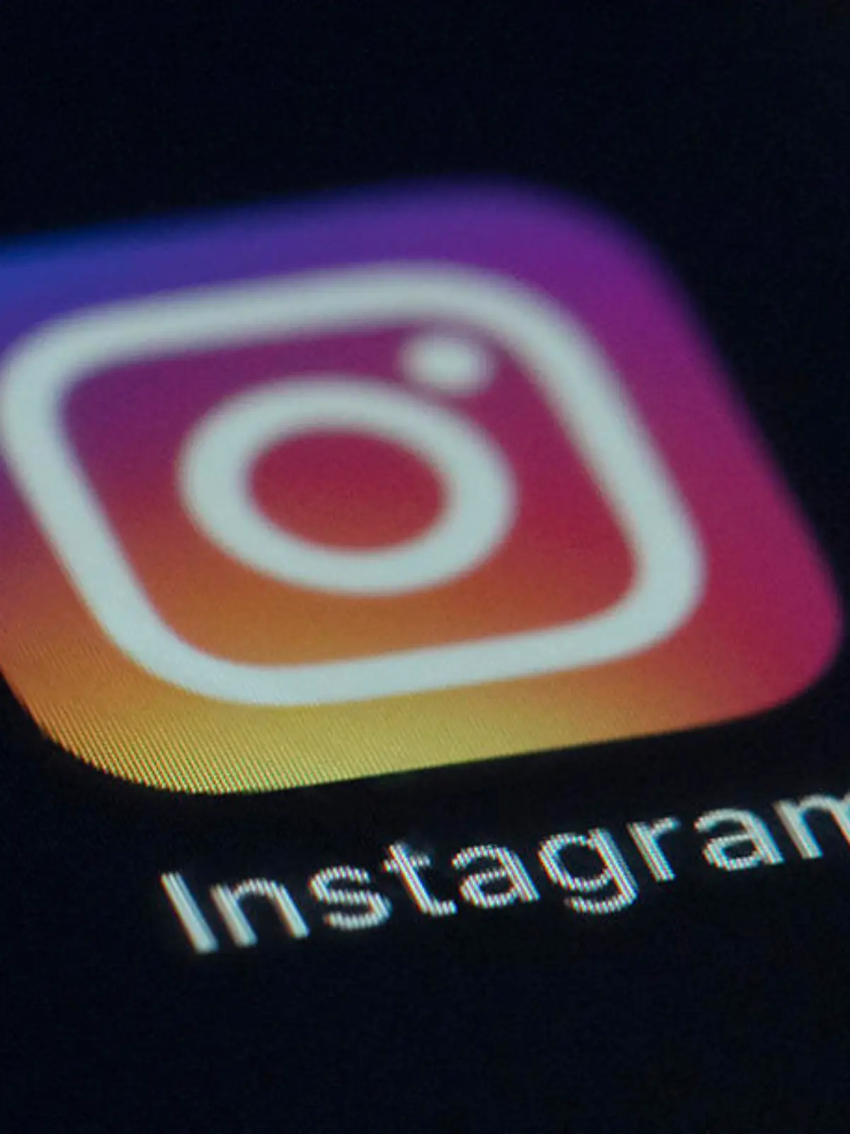FILE - This Friday, Aug. 23, 2019 photo shows the Instagram app icon on the screen of a mobile device in New York. Irish privacy regulators have opened two investigations into Instagram over the social media site's handling of children's data. Ireland's Data Protection Commission said on Sunday, Oct. 18, 2020 it launched the investigations in September after receiving complaints about the company. Facebook, which owns Instagram, said it's in “close contact” with the commission and is "cooperating with their inquiries.” (AP Photo/Jenny Kane, file)