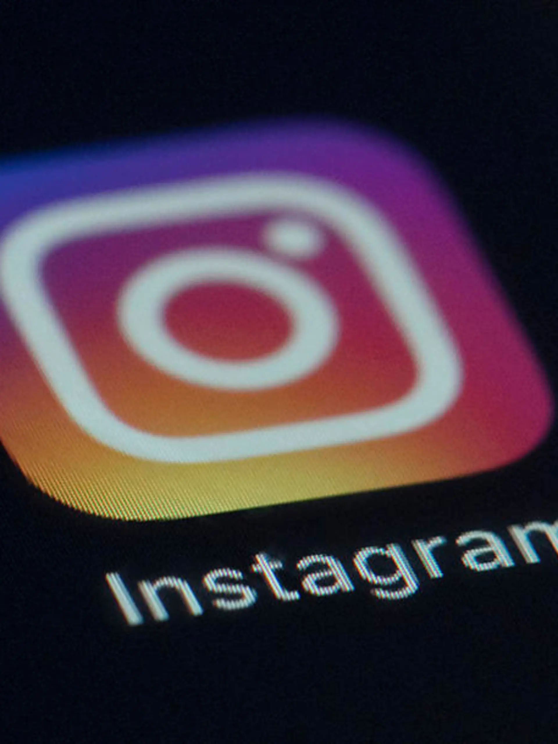 FILE - This Friday, Aug. 23, 2019 photo shows the Instagram app icon on the screen of a mobile device in New York. Irish privacy regulators have opened two investigations into Instagram over the social media site's handling of children's data. Ireland's Data Protection Commission said on Sunday, Oct. 18, 2020 it launched the investigations in September after receiving complaints about the company. Facebook, which owns Instagram, said it's in “close contact” with the commission and is "cooperating with their inquiries.” (AP Photo/Jenny Kane, file)