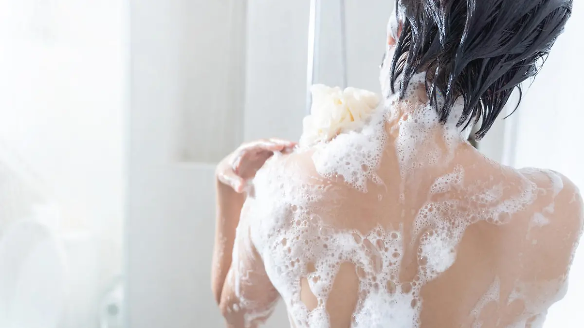 Asian woman washing hair and showering in the bathroom