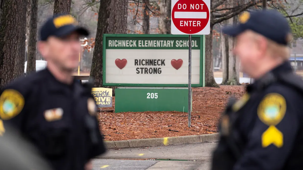 FILE - Police look on as students return to Richneck Elementary School following a school shooting in which a 6-year-old boy shot his teacher, Jan. 30, 2023, in Newport News, Va. Deja Taylor, the mother of the 6-year-old who shot his teacher at the Virginia elementary school, is expected to be sentenced Friday, Oct. 27, for felony child neglect, 10 months after her son used her handgun to critically wound the educator. (Billy Schuerman/The Virginian-Pilot via AP, File)