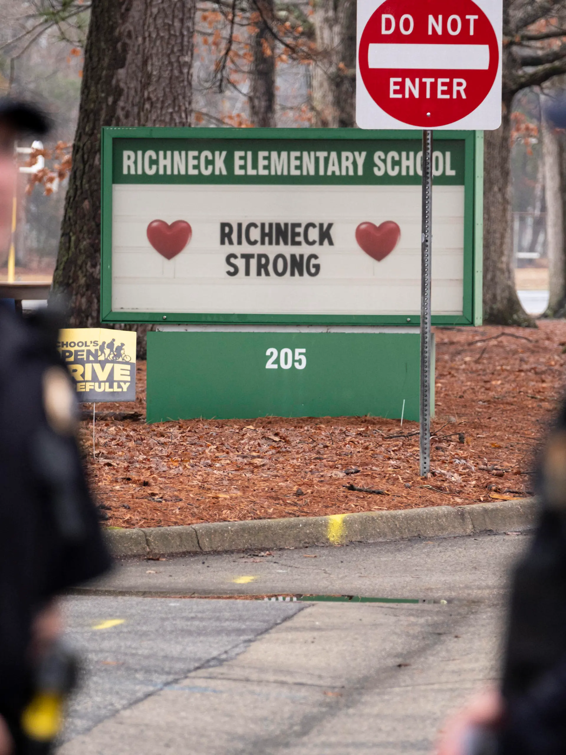 FILE - Police look on as students return to Richneck Elementary School following a school shooting in which a 6-year-old boy shot his teacher, Jan. 30, 2023, in Newport News, Va. Deja Taylor, the mother of the 6-year-old who shot his teacher at the Virginia elementary school, is expected to be sentenced Friday, Oct. 27, for felony child neglect, 10 months after her son used her handgun to critically wound the educator. (Billy Schuerman/The Virginian-Pilot via AP, File)