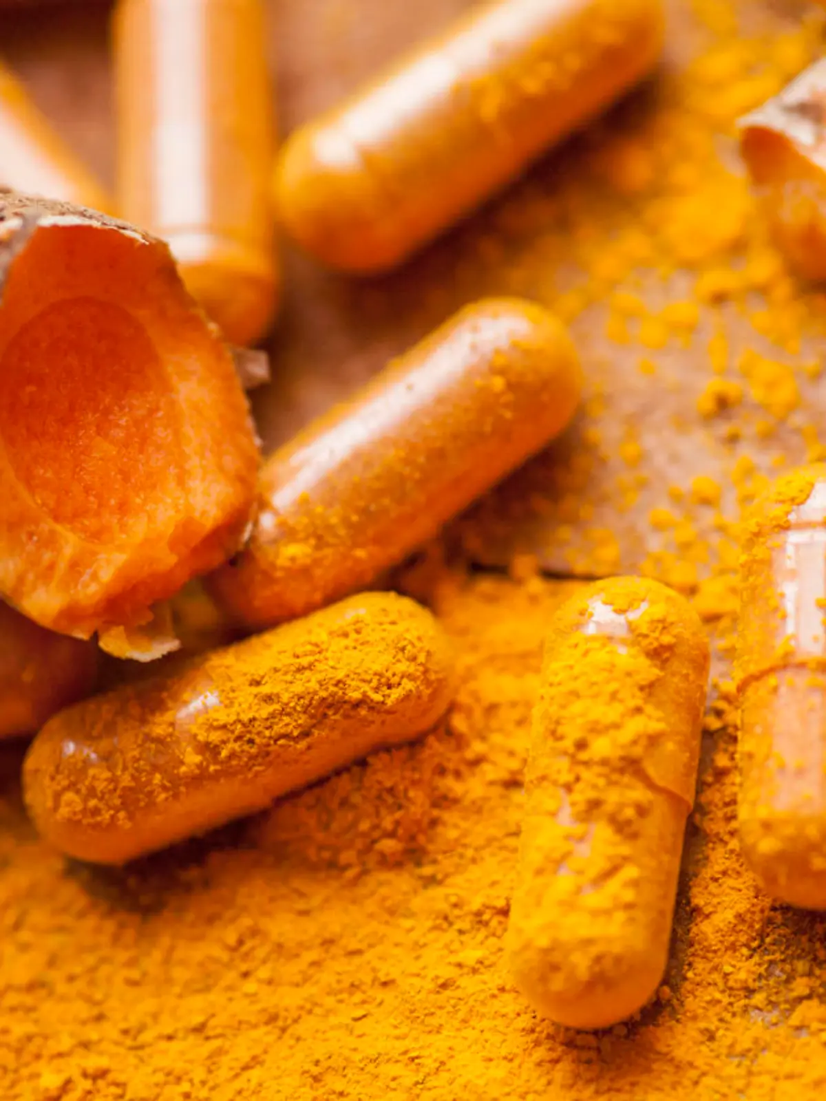 Raw organic turmeric root with powder and medicine herbal vitamin supplement pill capsules