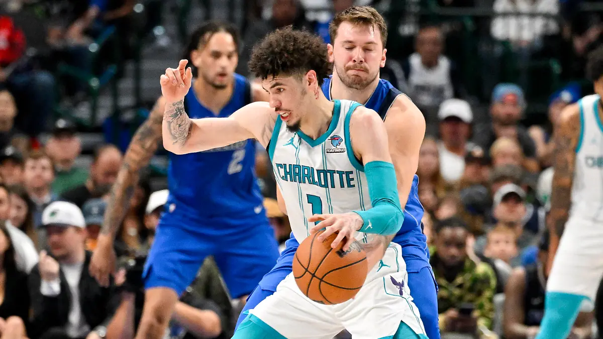 Nov 5, 2023; Dallas, Texas, USA; Dallas Mavericks guard Luka Doncic (77) attempts to knock the ball away from Charlotte Hornets guard LaMelo Ball (1) during the second quarter at the American Airlines Center. Mandatory Credit: Jerome Miron-USA TODAY Sports
