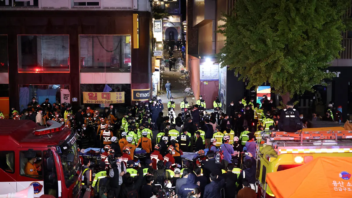 Rescue team and firefighters work at the scene where dozens of people were injured in a stampede during a Halloween festival in Seoul, South Korea, October 29, 2022. REUTERS/Kim Hong-ji