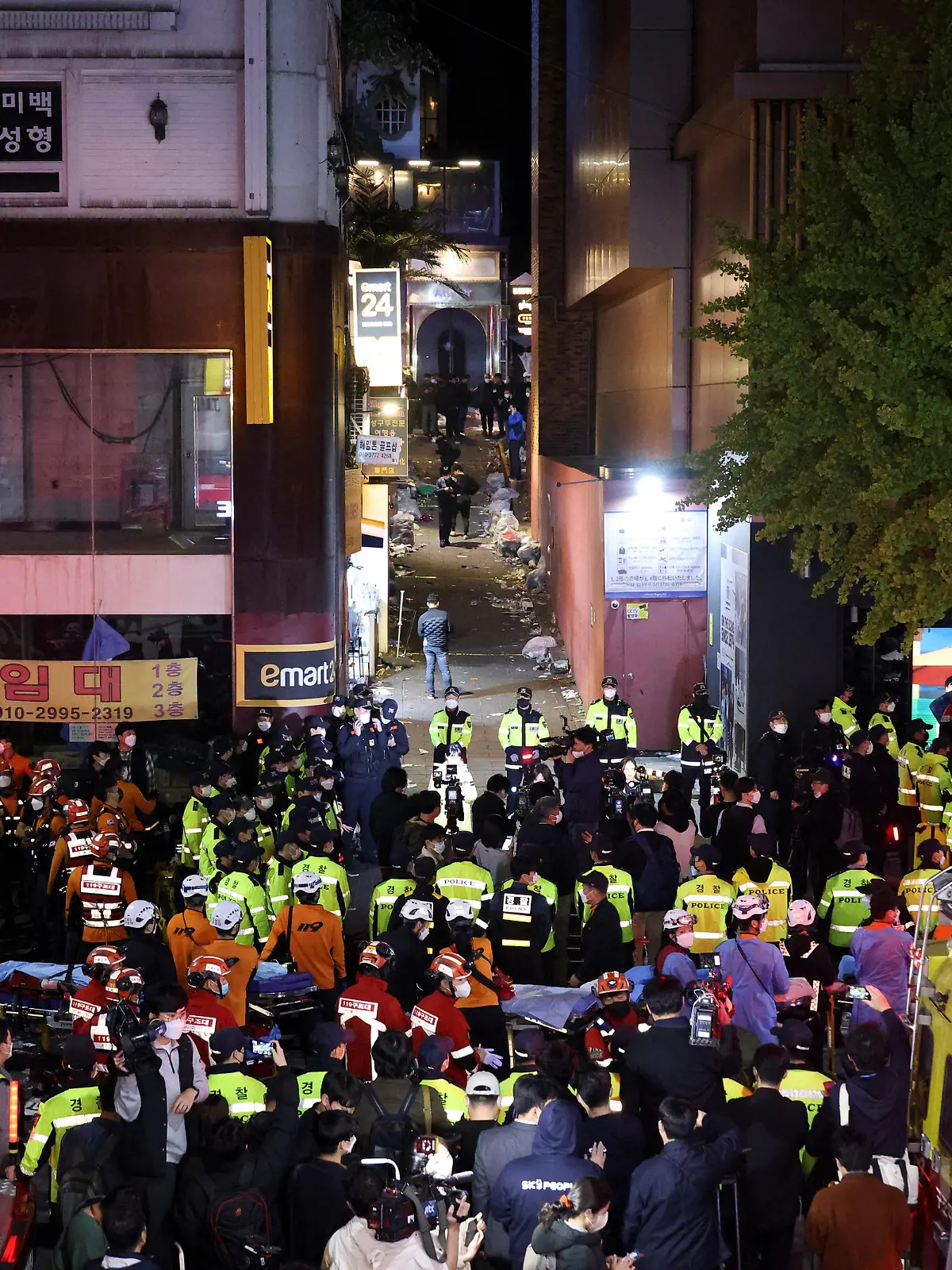 Rescue team and firefighters work at the scene where dozens of people were injured in a stampede during a Halloween festival in Seoul, South Korea, October 29, 2022. REUTERS/Kim Hong-ji