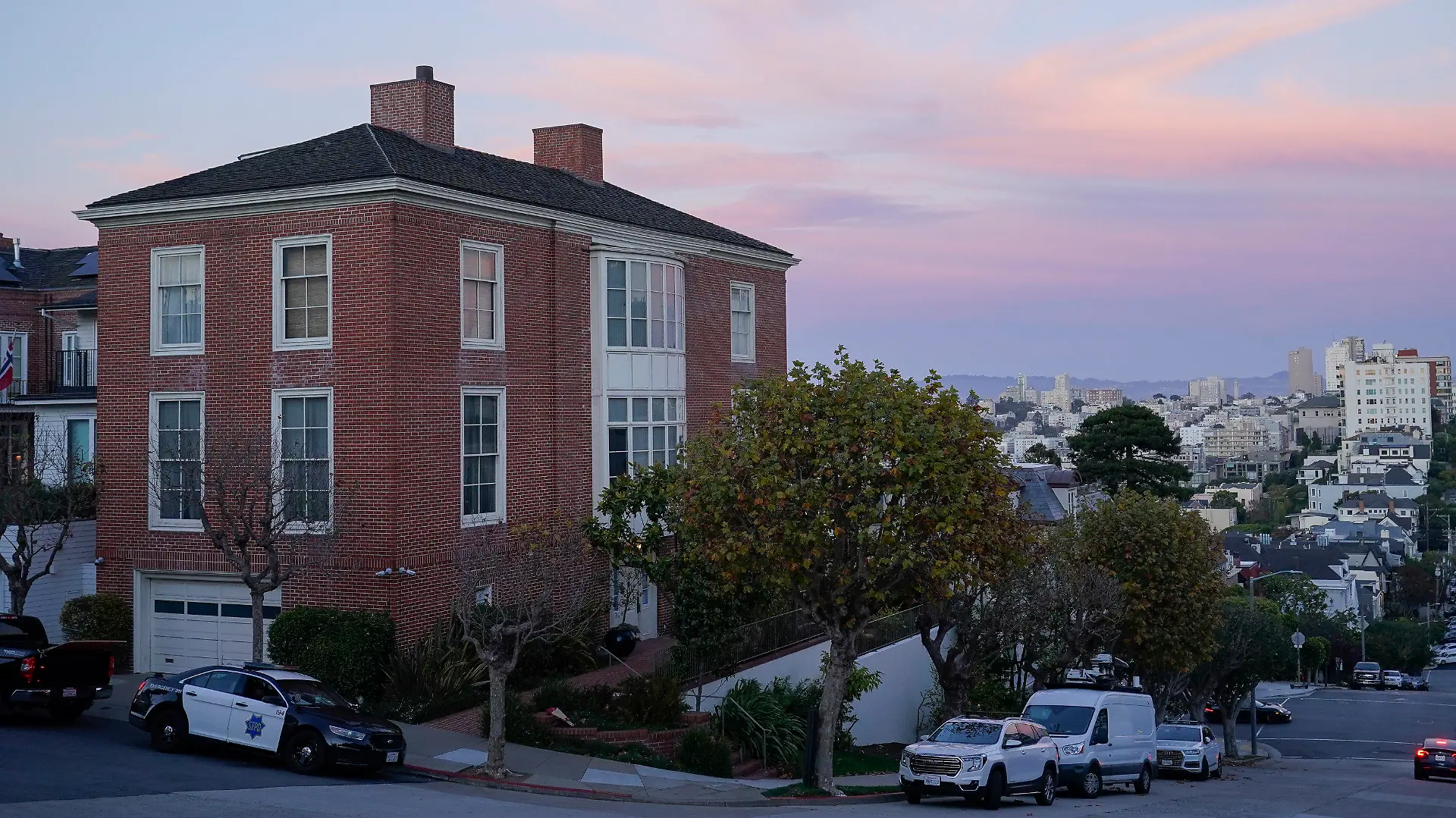 A police car can be seen parked outside the home of Paul Pelosi, the husband of House Speaker Nancy Pelosi, in San Francisco, Friday, Oct. 28, 2022. Paul Pelosi, was attacked and severely beaten by an assailant with a hammer who broke into their San Francisco home early Friday, according to people familiar with the investigation. (AP Photo/Godofredo A. Vásquez)