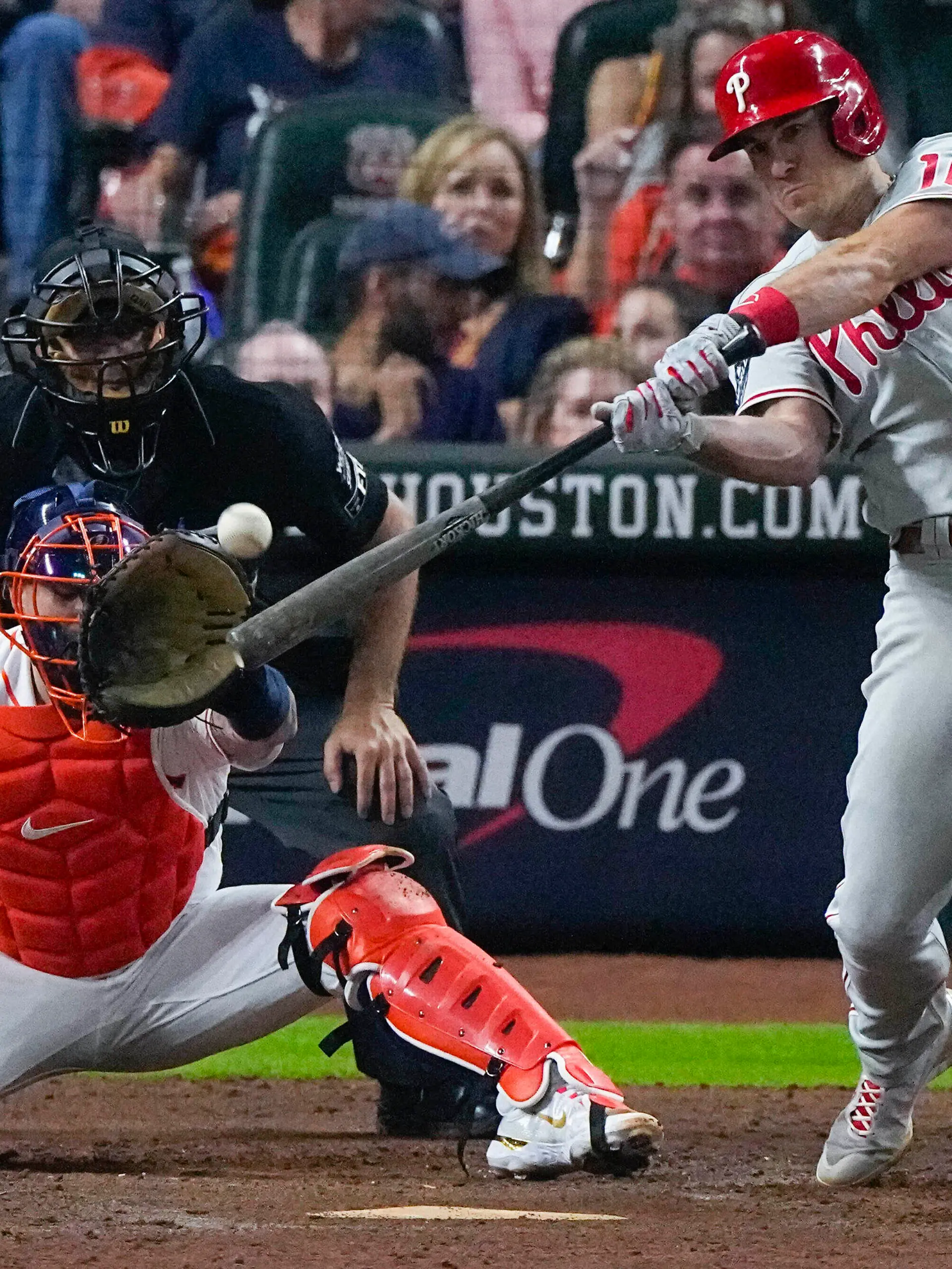 Philadelphia Phillies' J.T. Realmuto hits a home run during the 10th inning in Game 1 of baseball's World Series between the Houston Astros and the Philadelphia Phillies on Friday, Oct. 28, 2022, in Houston. (AP Photo/Sue Ogrocki)