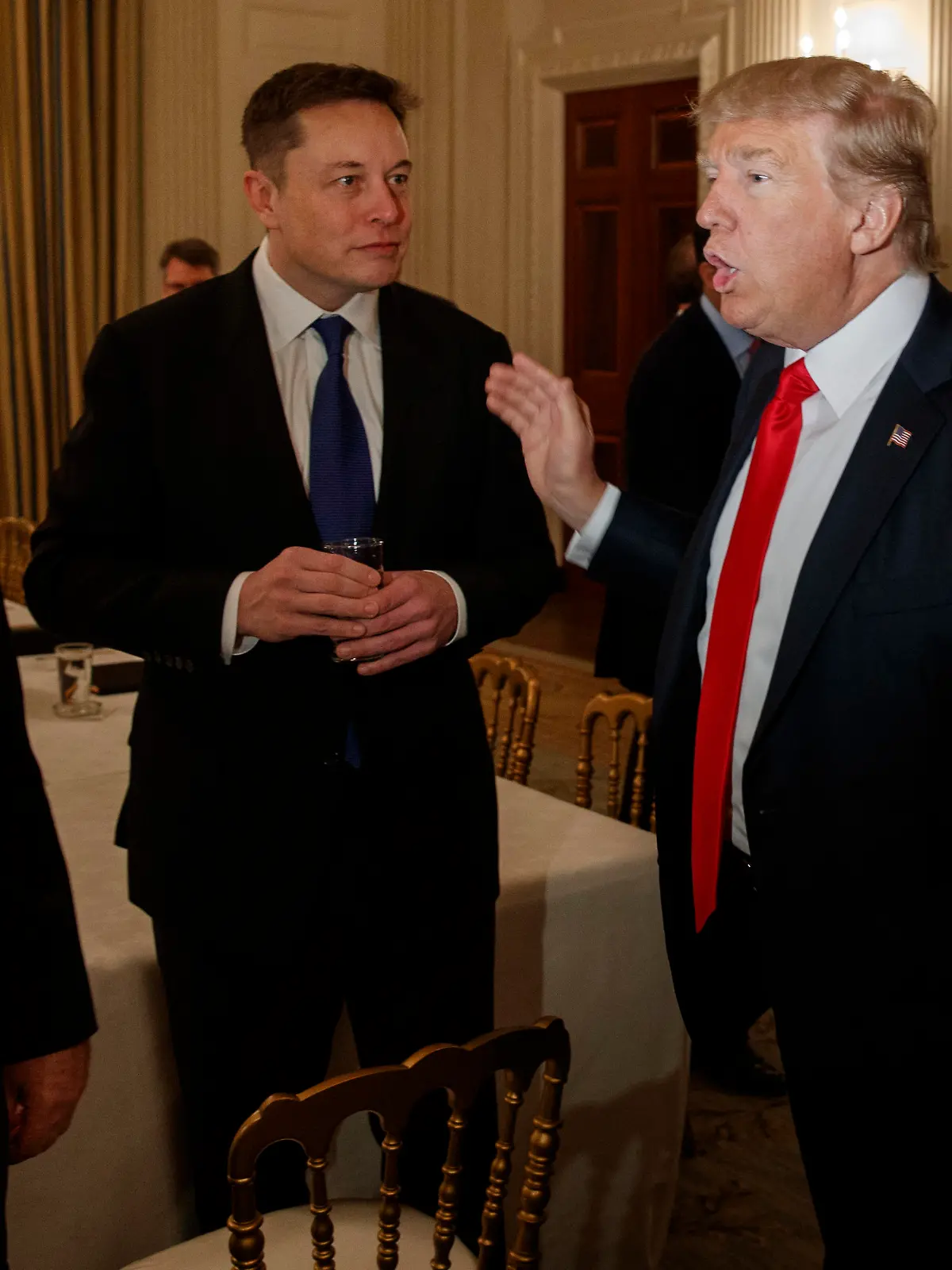 President Donald Trump talks with Tesla and SpaceX CEO Elon Musk, center, and White House chief strategist Steve Bannon during a meeting with business leaders in the State Dining Room of the White House in Washington, Friday, Feb. 3, 2017. (AP Photo/Evan Vucci)