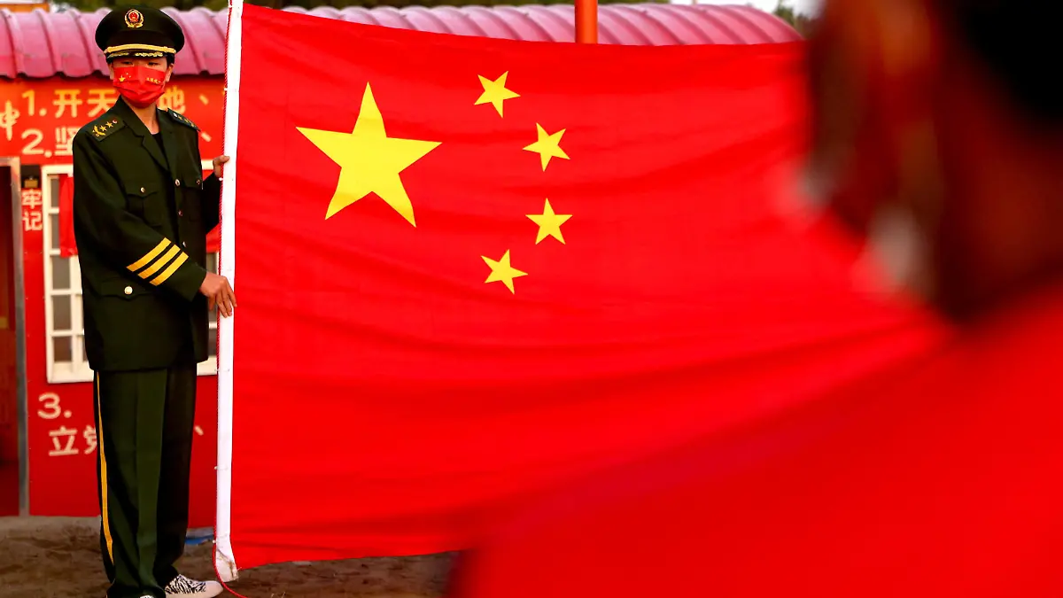 People attend the flag rising ceremony to celebrate China's national day at the base of the Taiwan People's Communist Party in Tainan, Taiwan, October 1, 2022. REUTERS/Ann Wang
