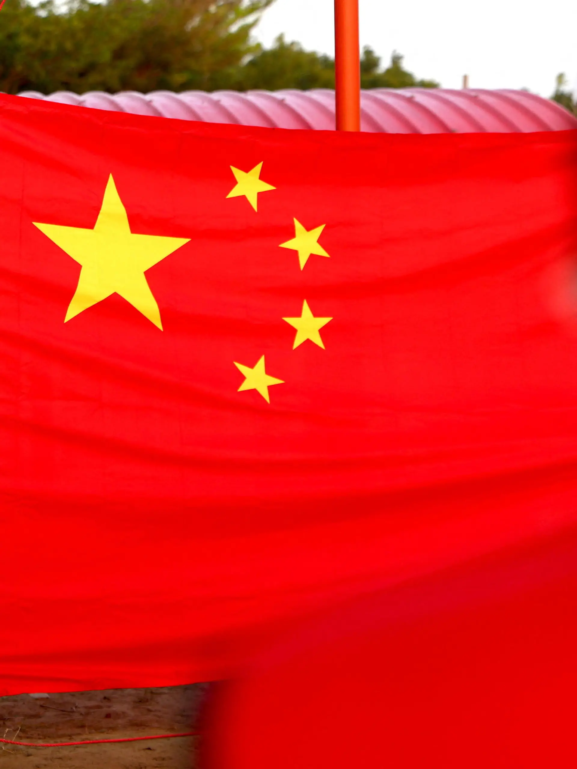 People attend the flag rising ceremony to celebrate China's national day at the base of the Taiwan People's Communist Party in Tainan, Taiwan, October 1, 2022. REUTERS/Ann Wang